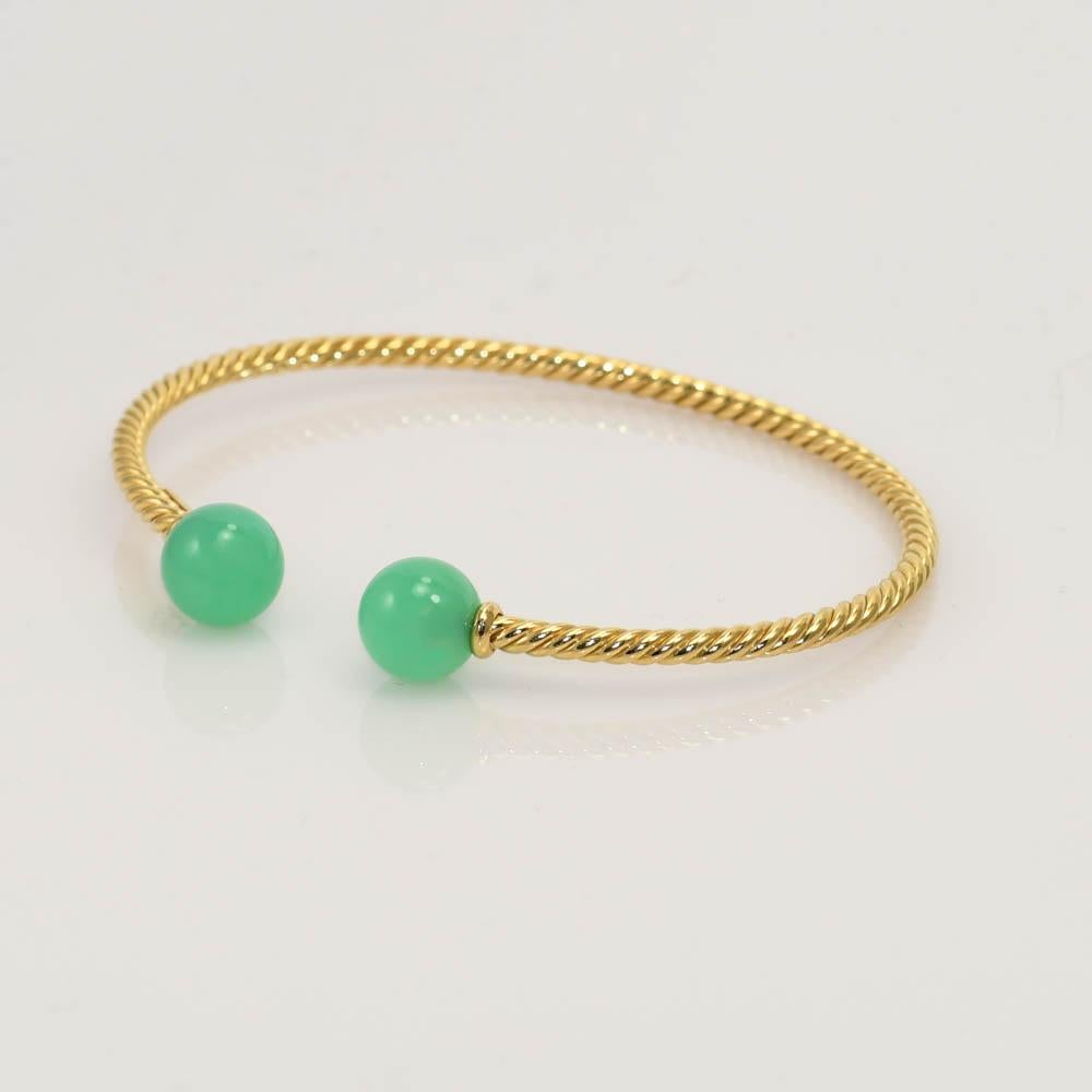 Ladies 18k yellow gold David Yurman spiral cable bangle with chrysoprase beads.
Stamped M, D.Y. 750 and weighs 6.8 grams.
The green chrysoprase beads are green jade color.
The cable bracelet measures 2.5mm wide and fits up to 6 1/2 inch wrist.
Comes