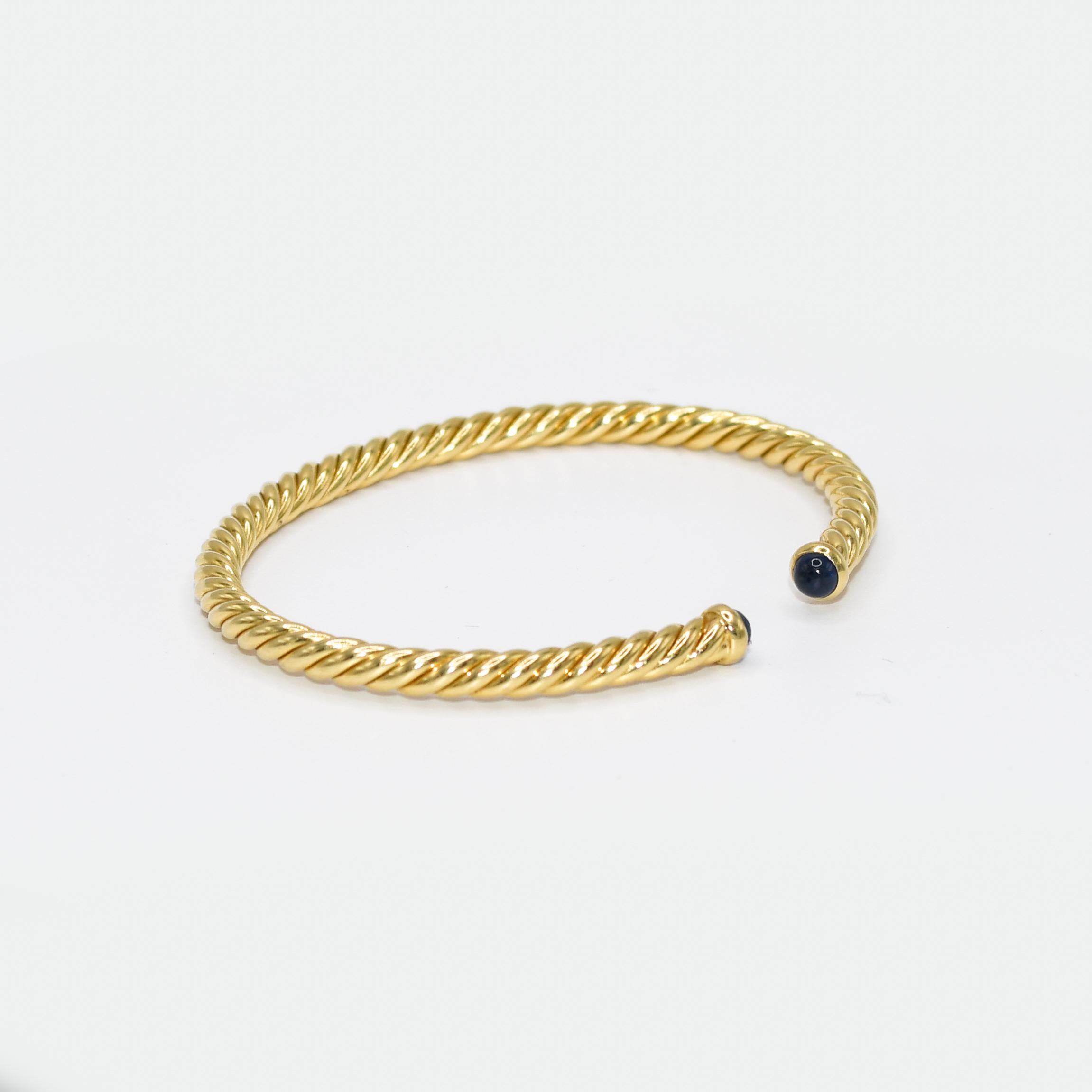 18K Yellow Gold David Yurman Spira Cable Bracelet & Sapphire ,8.5g
Ladies 18k yellow gold David Yurman Spira cable bracelet.
Blue sapphire end pieces.
Stamped D.Y. 750, M and weighs 8.5 grams.
The bangle measures 4mm thick and will fit up to a 6