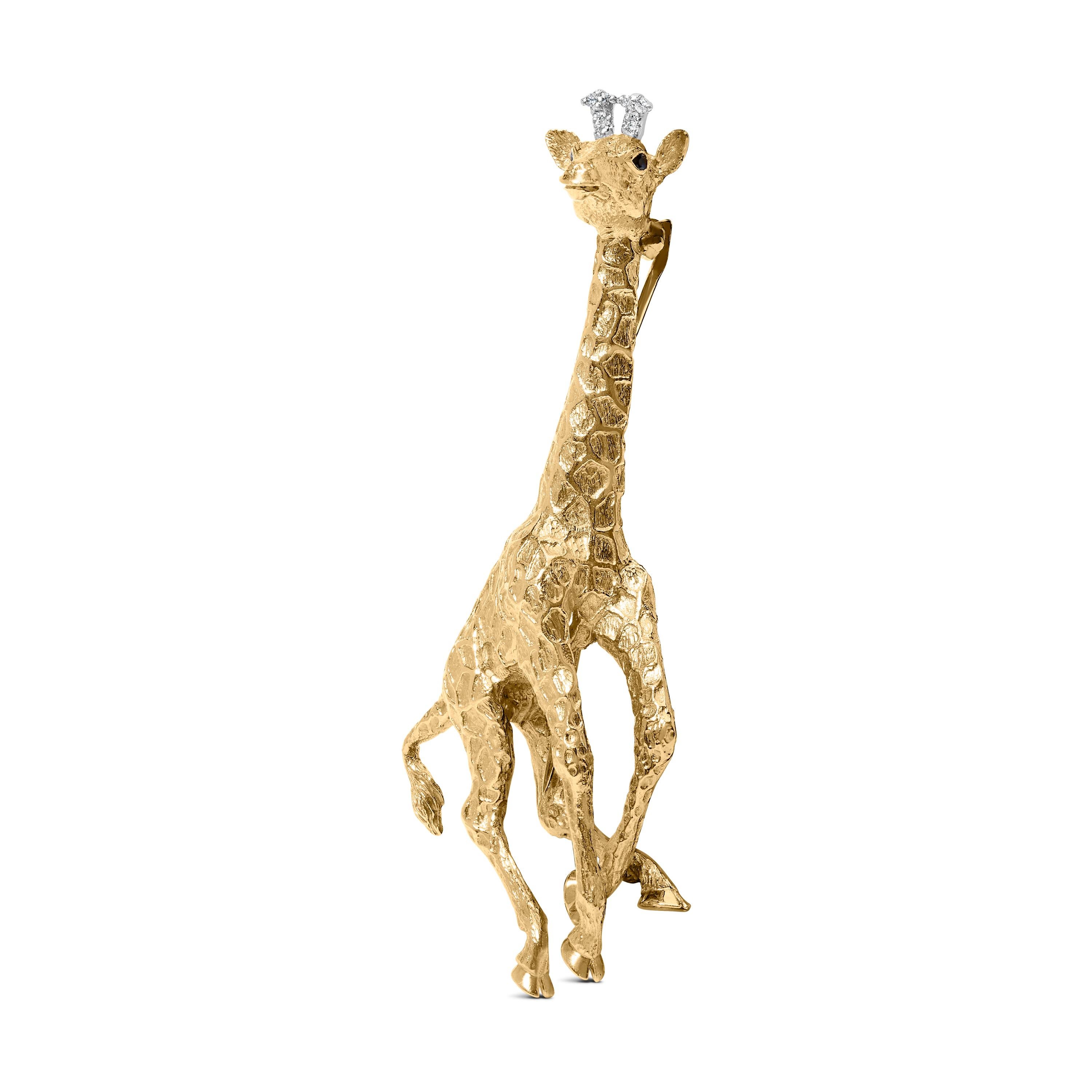 Elegance meets whimsical luxury with this exquisite 18 Karat Yellow Hold giraffe brooch, a testament to meticulous artistry and a celebration of nature’s grace. The giraffe, rendered in a textured finish that artfully mimics its natural pattern, is