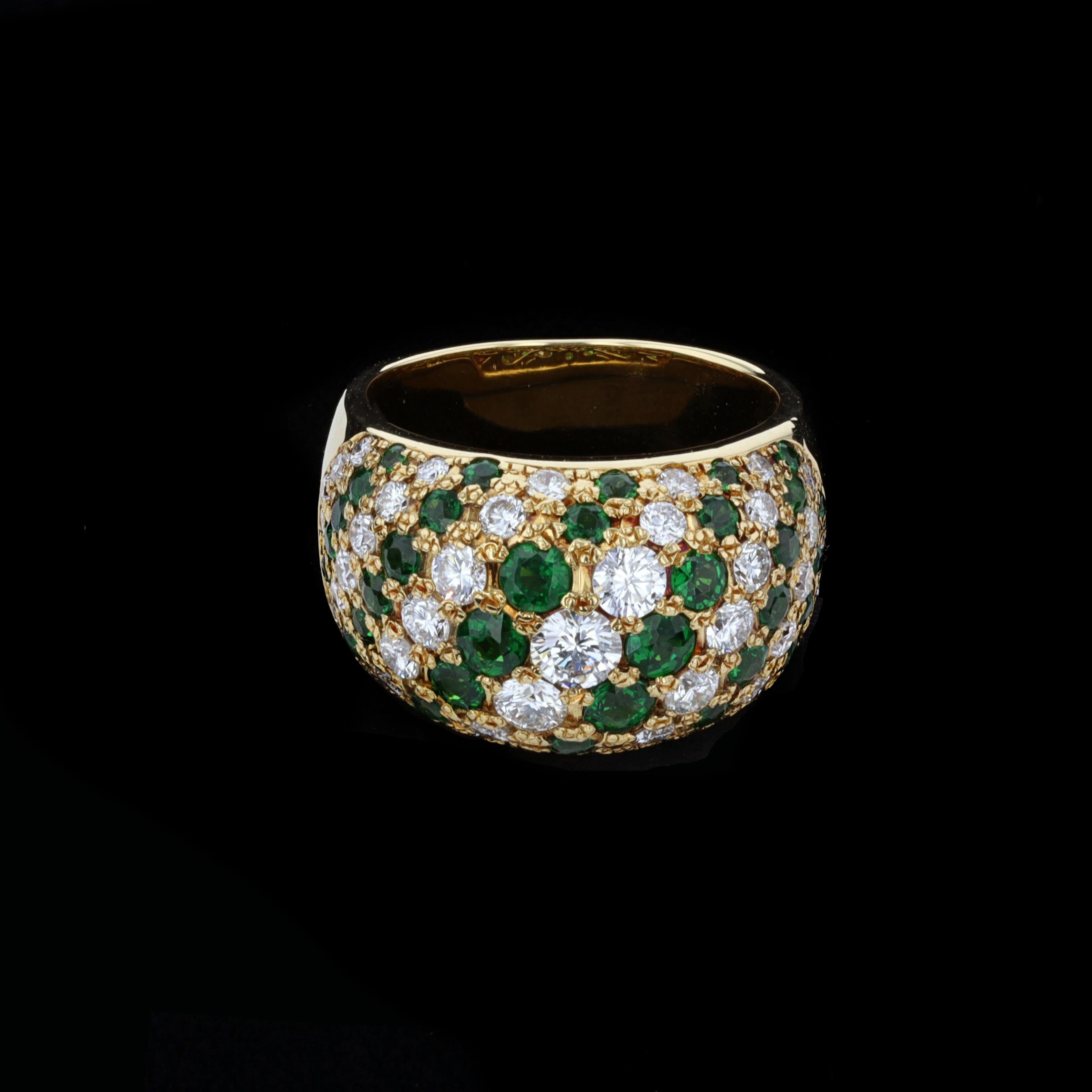 Intricate and Elegant 1.43ct Diamond 1.80ct Emerald 18k Yellow Gold Ring. The ring is set with sparkling round cut diamonds that weigh approximately 1.43ct. The color of these diamonds is F with VS1 clarity. The diamonds are accentuated by lovely