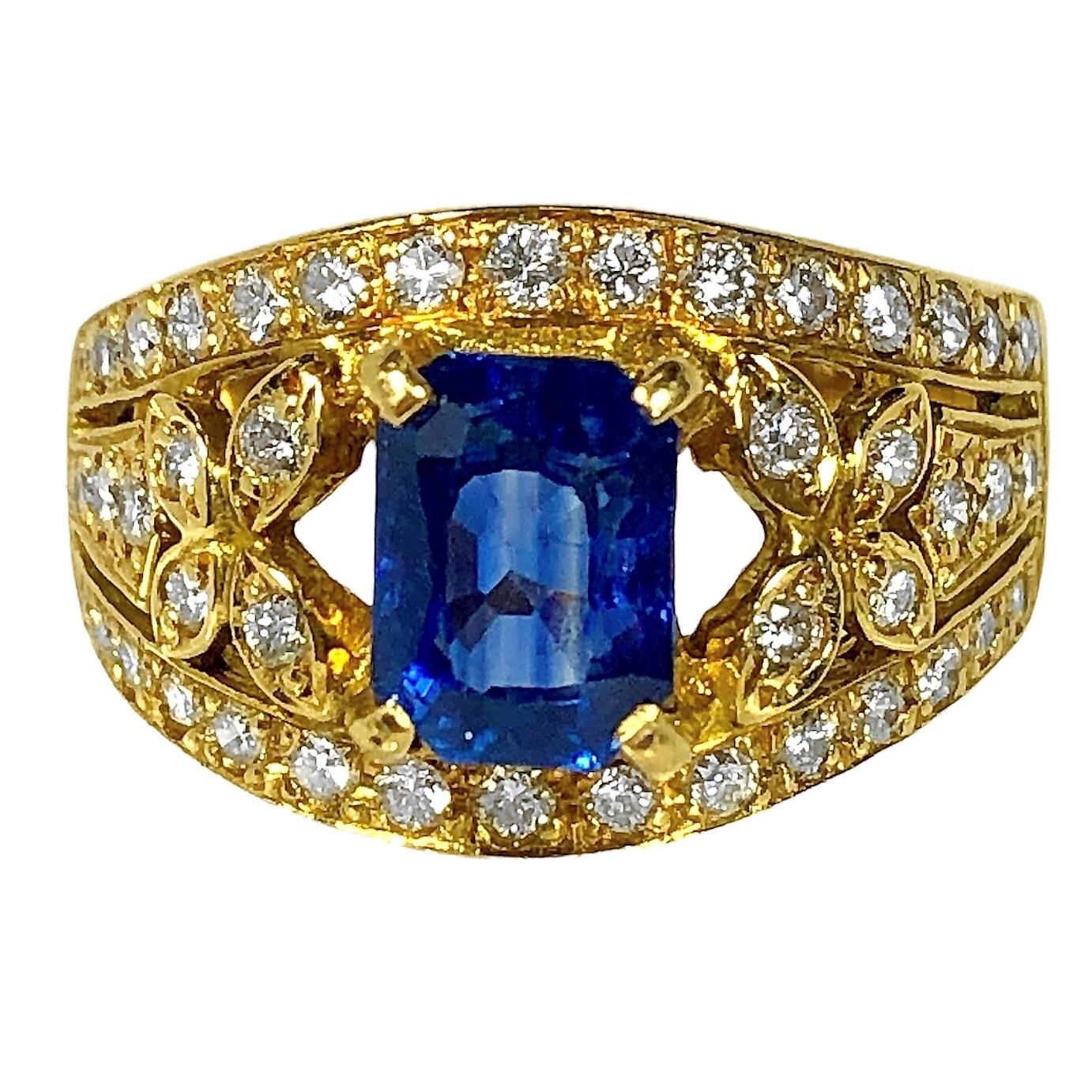 This lovely and dainty Late-20th Century cocktail ring has, at it's center, one rich blue modified emerald cut sapphire weighing exactly 1.39ct, flanked and surrounded by 44 brilliant cut diamonds having a total exact weight of .50ct.  All diamonds