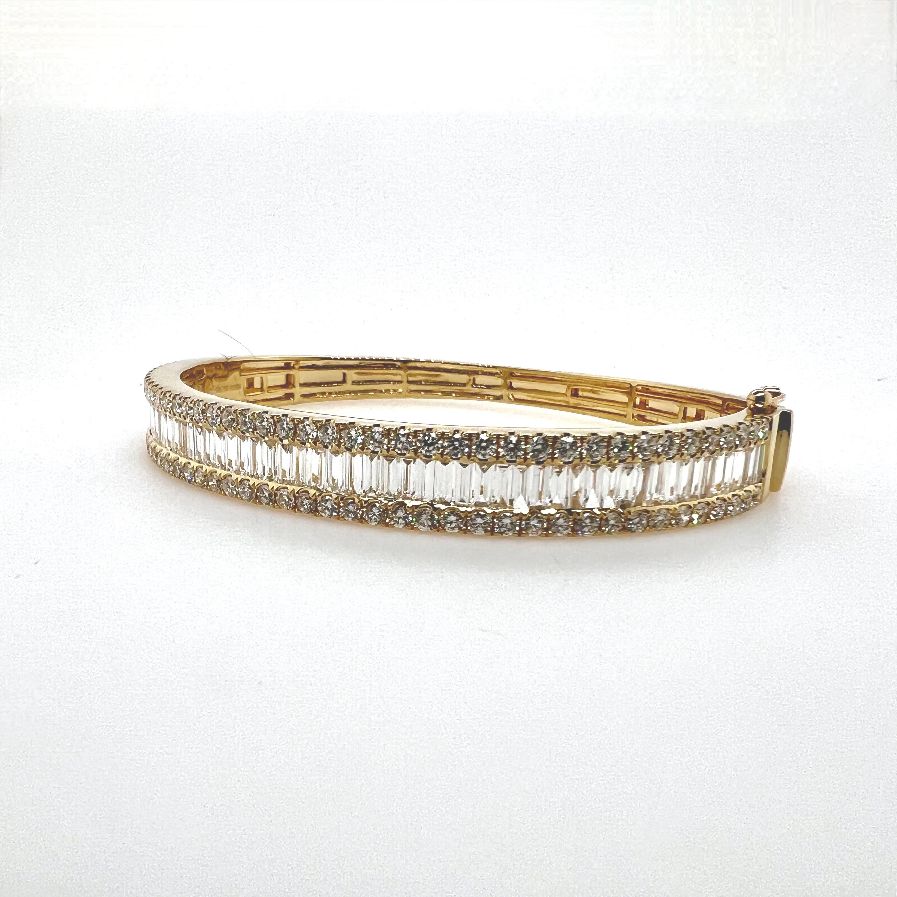 This gorgeous 18k yellow gold diamond bangle has beautiful baguette diamonds channeled set while the shoulders have round brilliant diamonds prong set.  At a little over 1/4'' in width, the bangle can be stacked with other items or can be worn solo