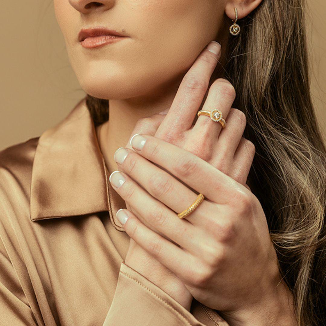 This classic diamond band is handcrafted with 18K yellow gold, and adorned with a dazzling pavé of meticulously set diamonds. The diamonds radiate brilliance from every angle, catching the light with every movement. The continuous shimmer enhances