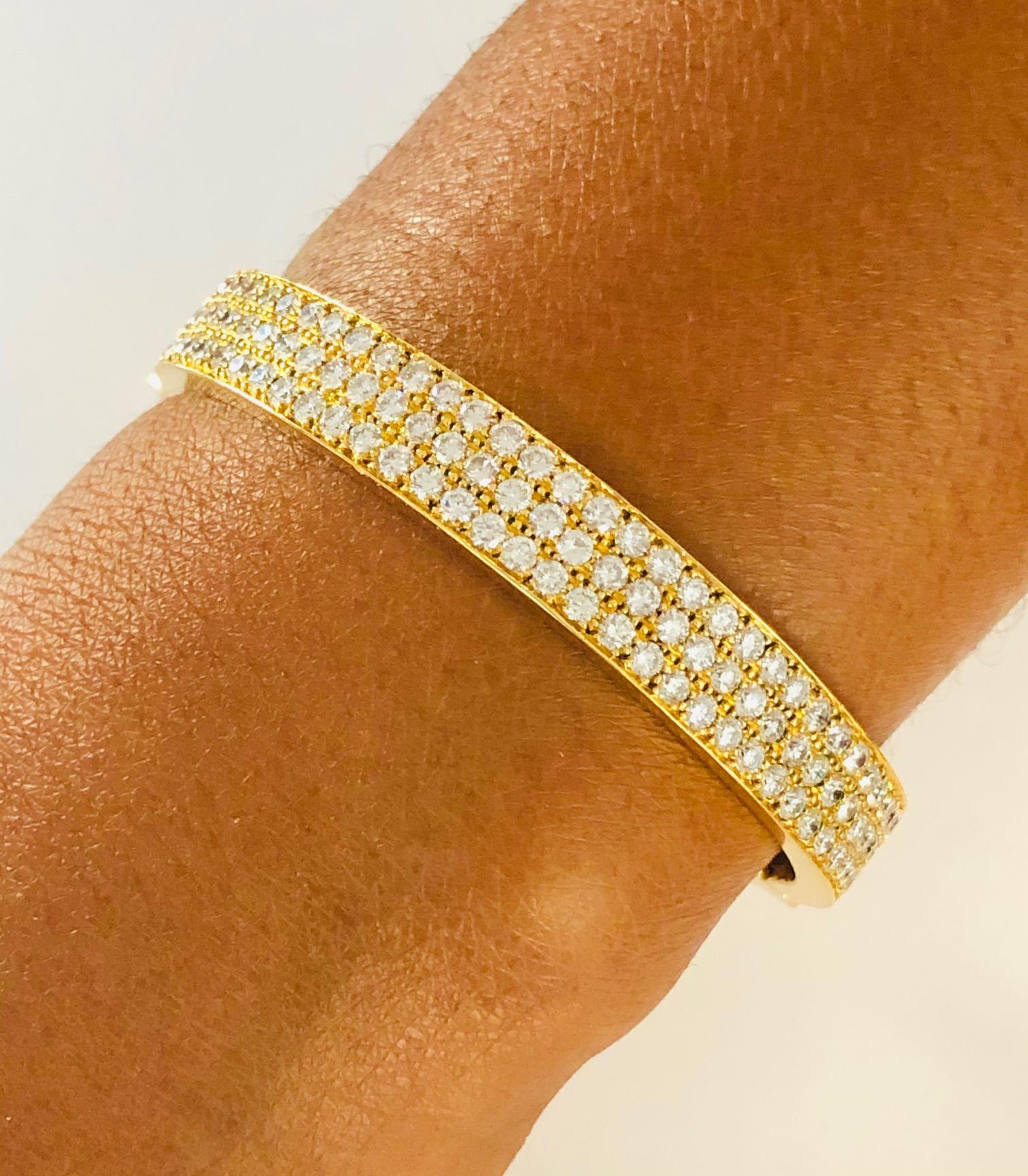 Beautiful 18K Yellow Gold Bangle Bracelet , set with 105 fine Diamonds 5.35 carats., 
Also available in 18K White Gold as shown in the photograph posted.
Bracelet Width 5/16 Inch ( 0.9 CM )

We deign and manufacture our jewelry in our workshop,