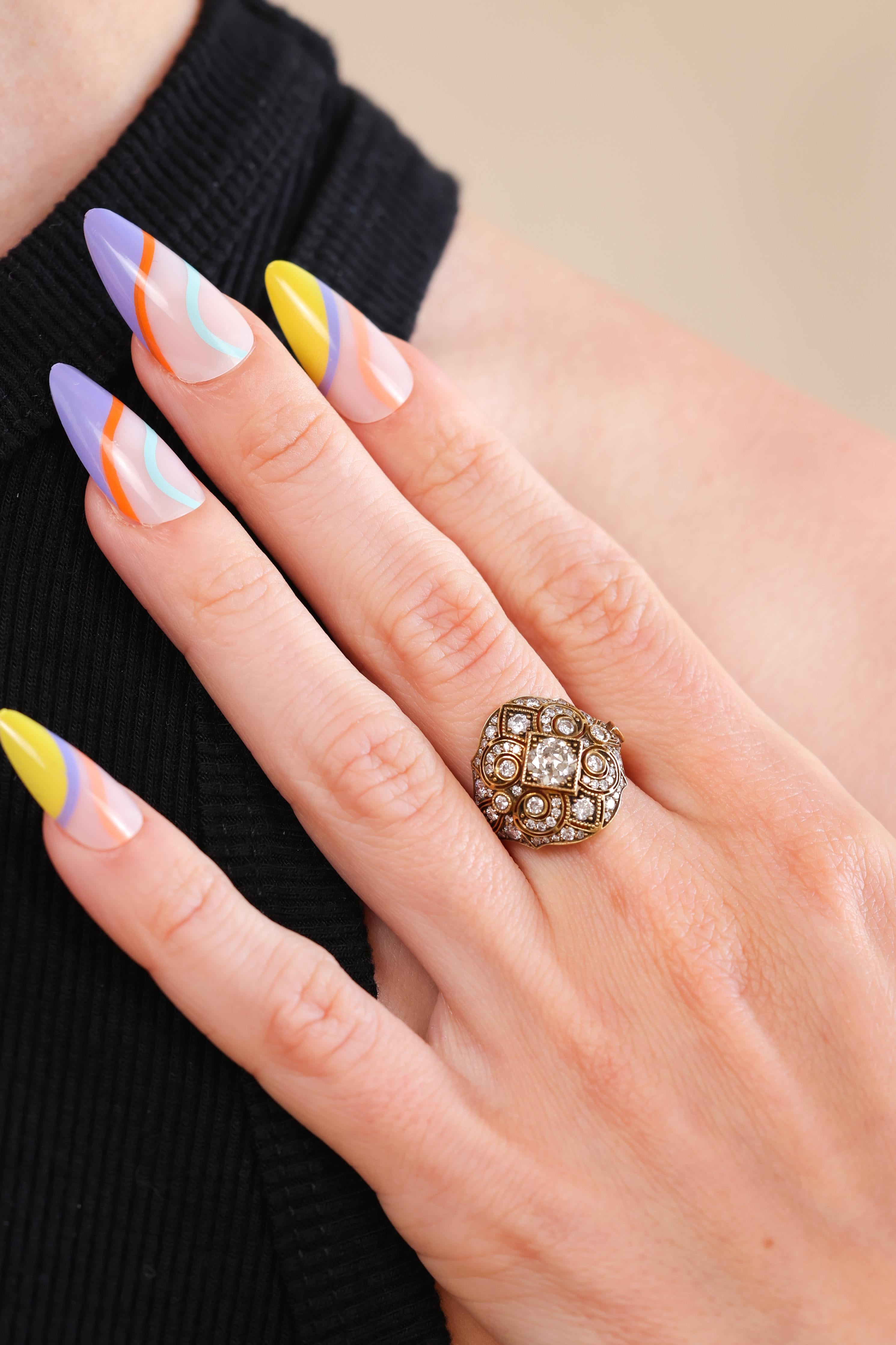 This is an extraordinary Trumpet & Horn Original ring that we are proud to offer in our vintage-inspired collection. The handmade 18k yellow gold bombe style ring centers a 0.60ct Old European Cut diamond graded I color and SI2 clarity. This
