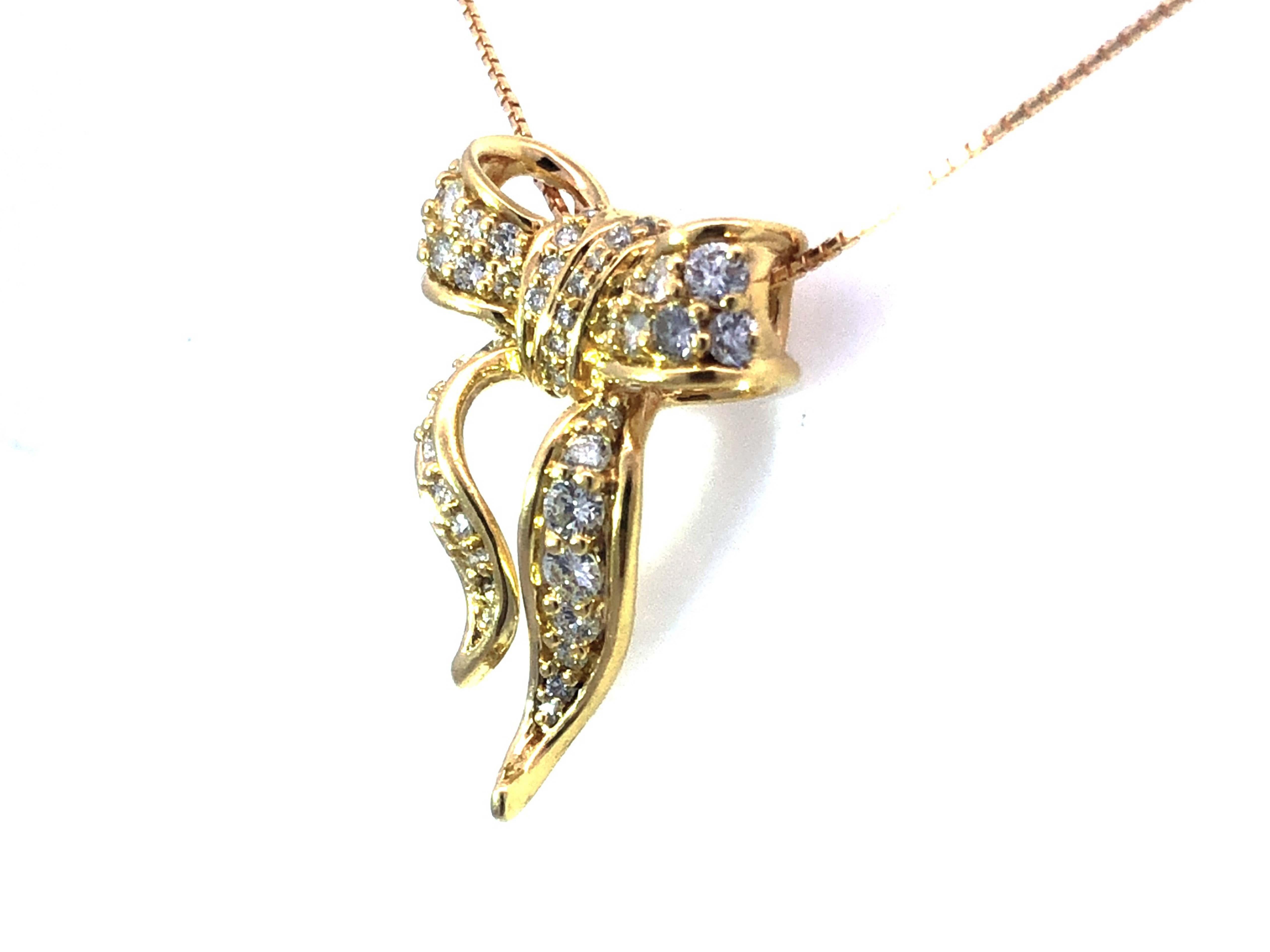 Anhänger und Kette aus 18 Karat Gelbgold mit Diamantschleife (Rundschliff)