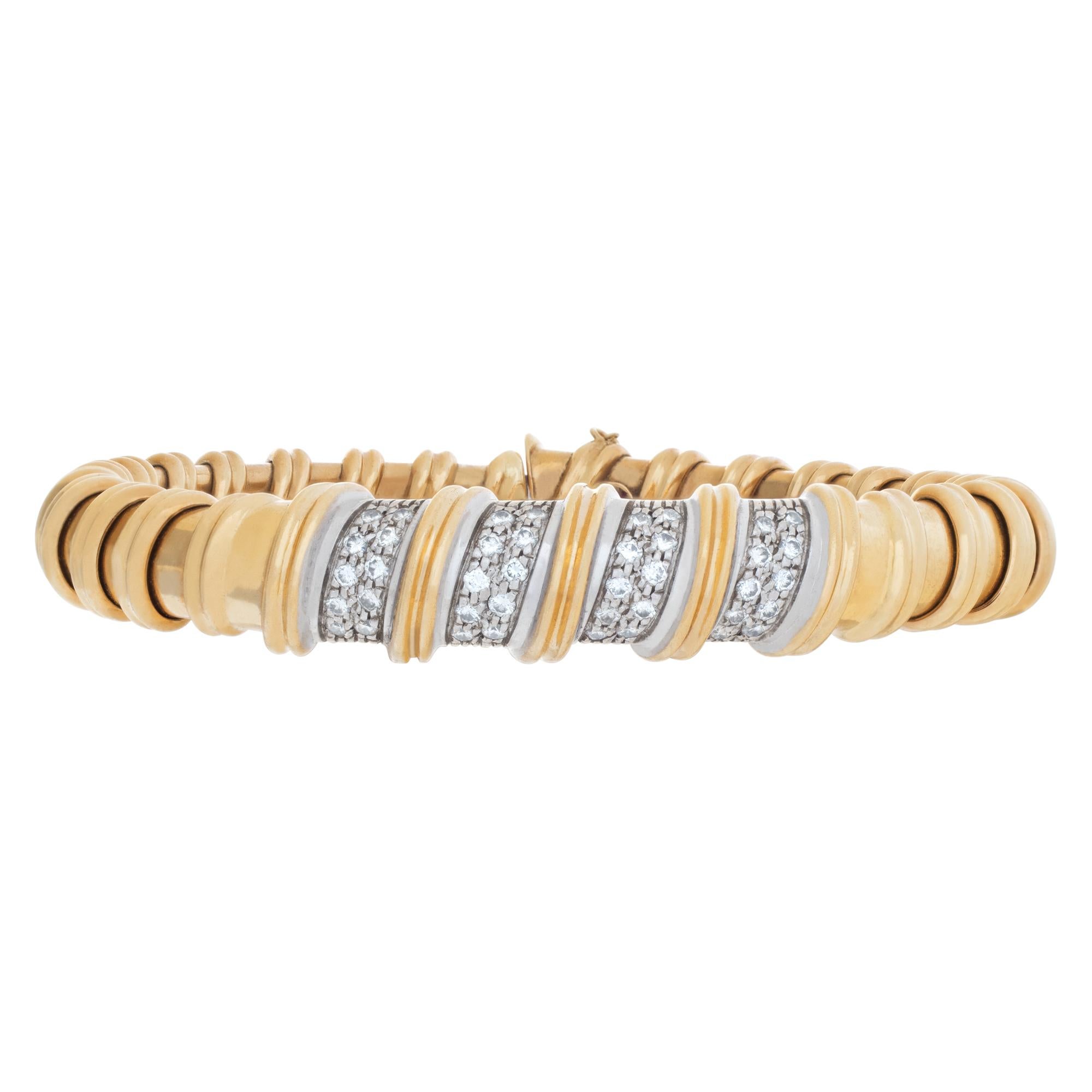 Stunning ribbed diamond bangle braceletin 18k yellow gold with approximately 0.50 carats in pave diamonds. Signed 