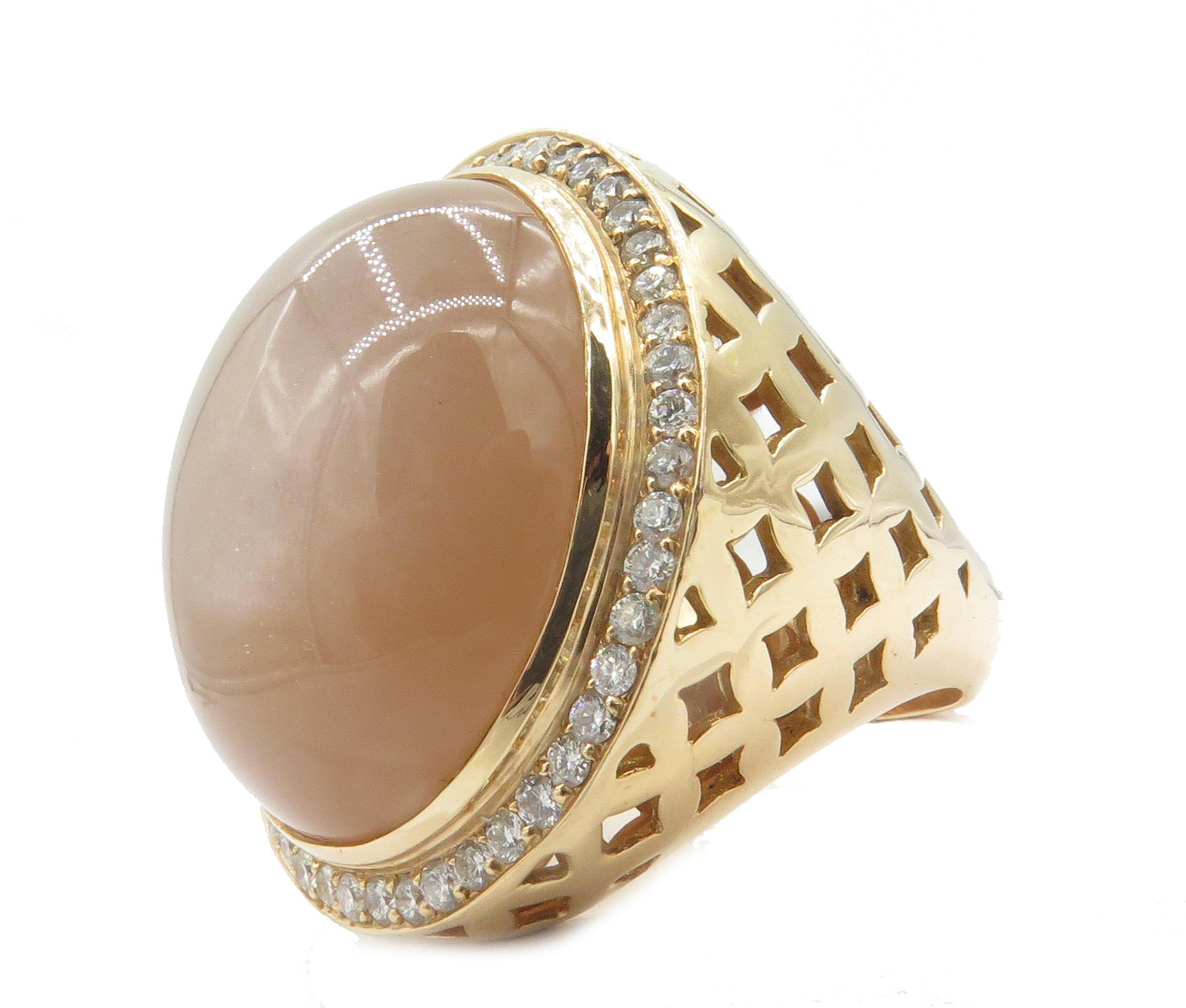 A beautifully, crafted and designed 18k yellow gold dome ring. With a big beautiful cabochon moonstone in the center beautifully set on 18k yellow gold surround the Moonstone is a beautiful array of round beautiful diamonds. This is US ring size 7.