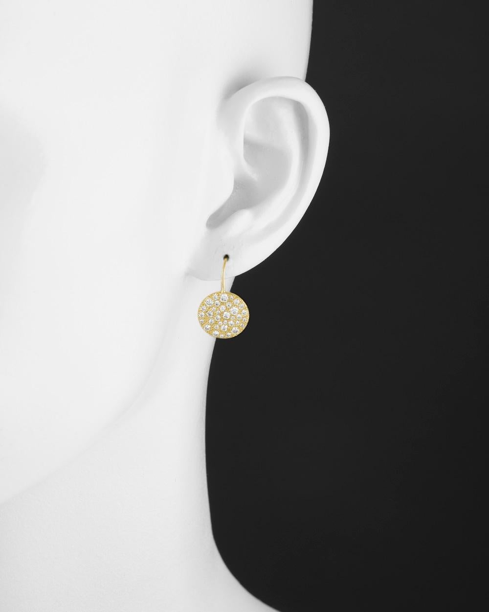 Circle drop earrings in polished 18k yellow gold, pavé-set with various-sized round-cut diamonds weighing 1.20 total carats. Frenchwires with hinged leverbacks. 0.85