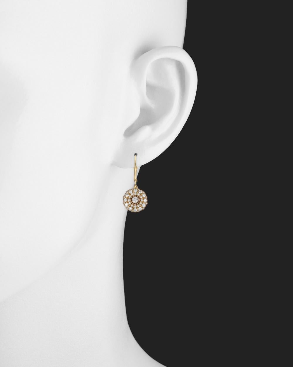 Circular-shaped diamond cluster drop earrings, in 18k yellow gold with elegant milgraining, scalloped frame and bezel-set diamond accent at the base. Cluster suspended from a polished 18k yellow gold French wire with hinged leverback. Diamonds