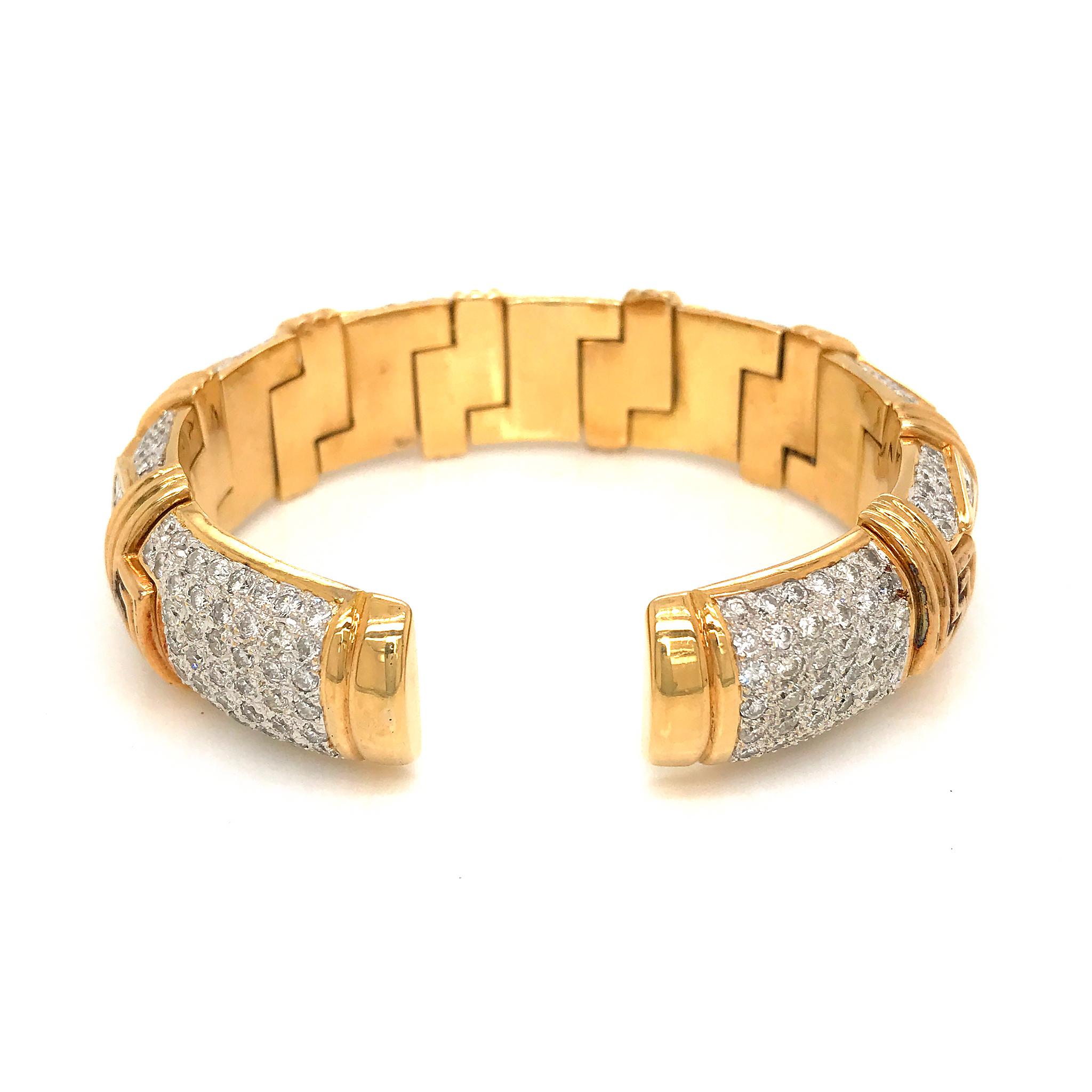 *** The bangle fits from 6.5 inches wrist size and is flexible since it is an open cuff *** 
METAL TYPE: 18k Yellow Gold
STONE WEIGHT: 7.5ct twd (estimated)
TOTAL WEIGHT: 107 grams
WIDTH: 15.7mm 
