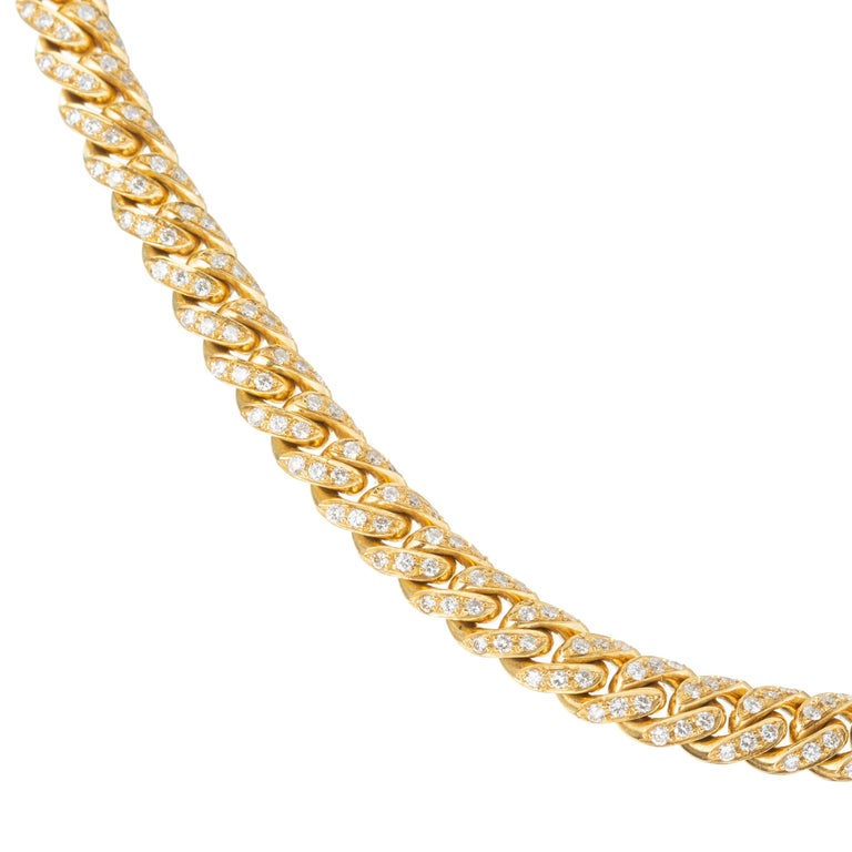 Curb-link style chain necklace in 18k yellow gold, the top side is entirely pave-set with diamonds throughout totaling approximately 12.00ct.  The reverse side has a polished finish and can be worn as a plain gold neck chain.  Hidden style clasp