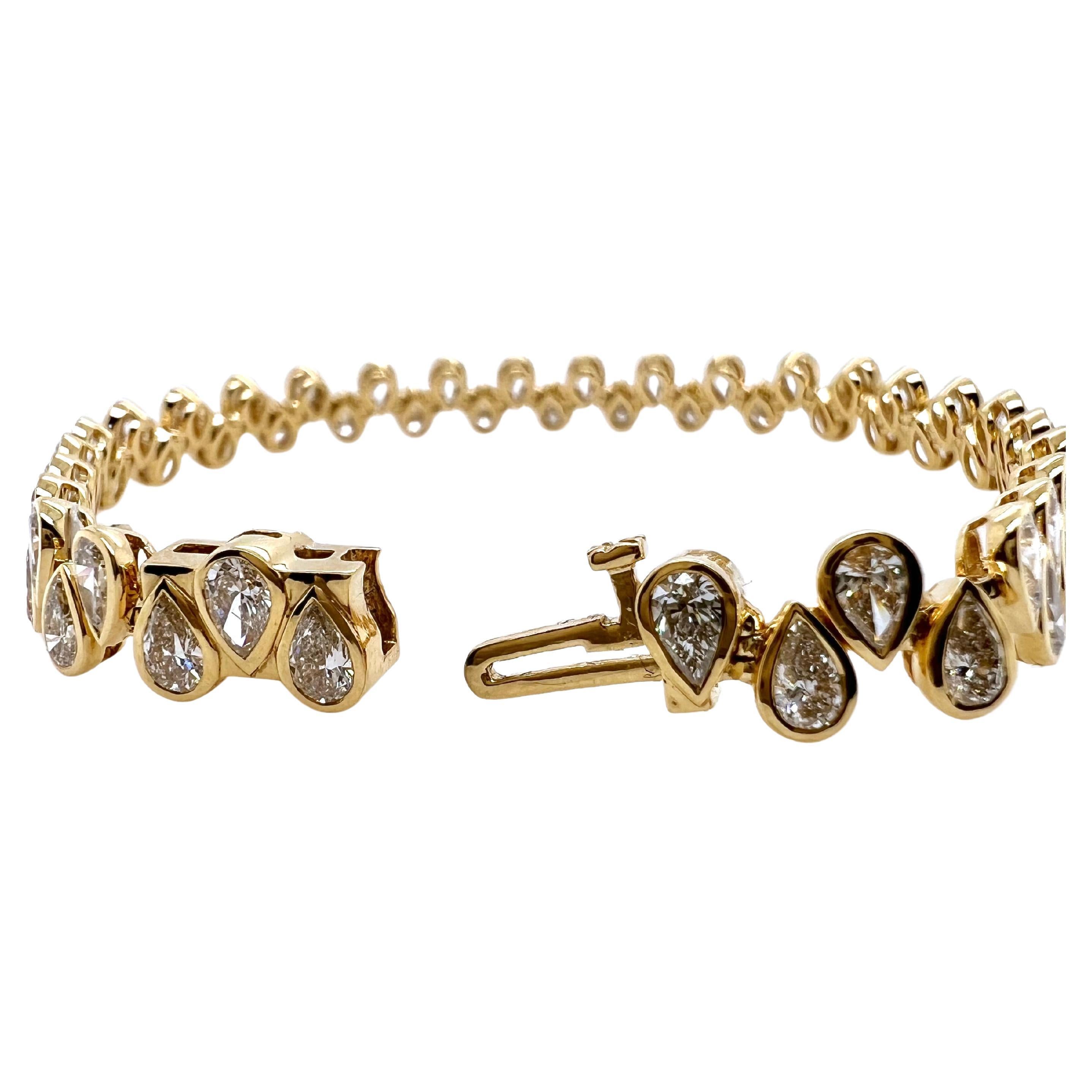 This gorgeous tennis bracelet will be the talk of the town!  The alternating pear shape pattern is unique and
contemporary.  The pear shape diamonds are bezel set in 18k yellow gold with no prongs protruding up.  This
enables you to wear the