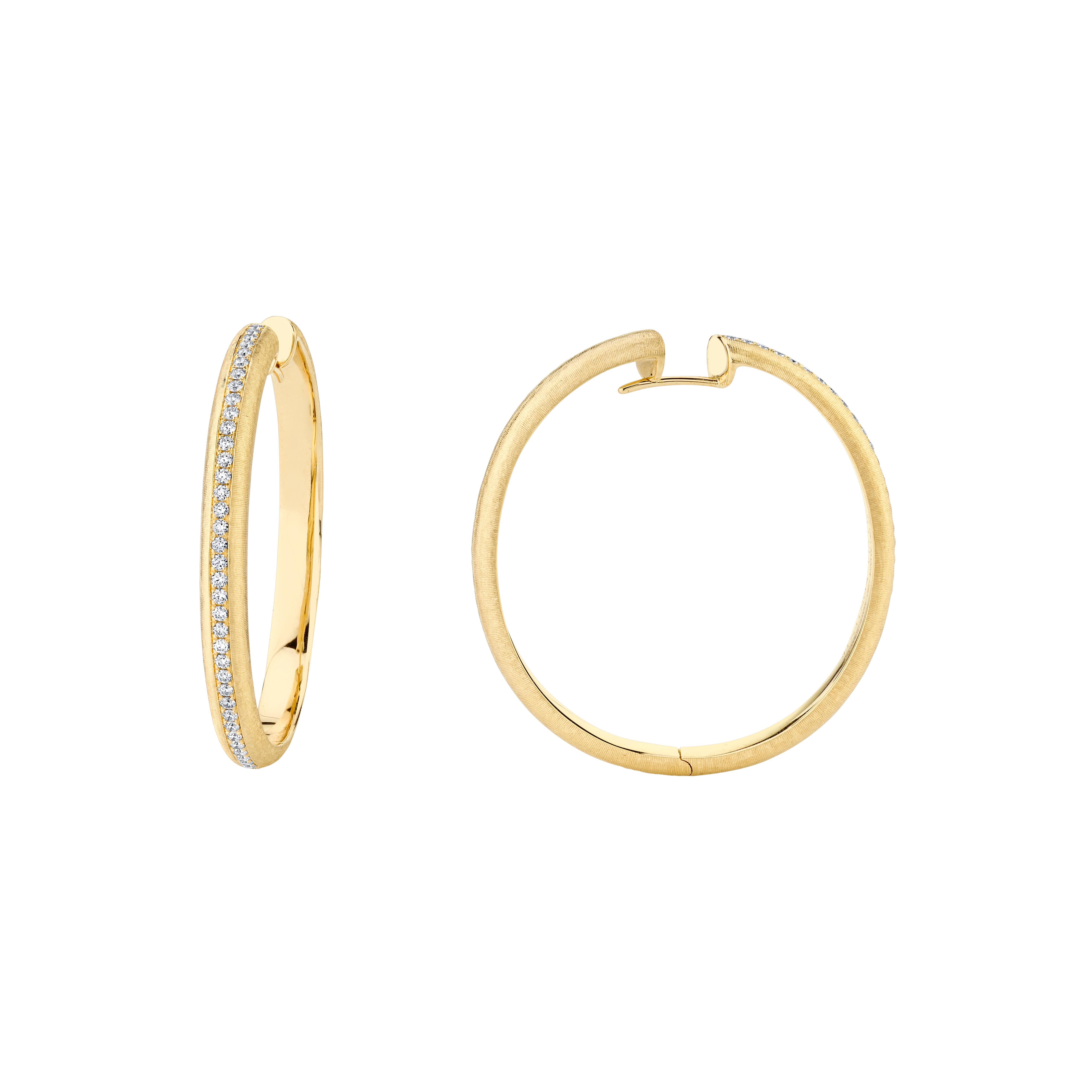 Style #: XH354E.
SYLVIA KONTENTE 18K Yellow gold diamond hoop earrings with hand-engraved finish.
Precision-cut, round brilliant diamonds.
Diamond total weight: 0.72ct tw.
Diamond color/clarity: DEF/VVS VS.
Hand-engraved finish - The ancient art of