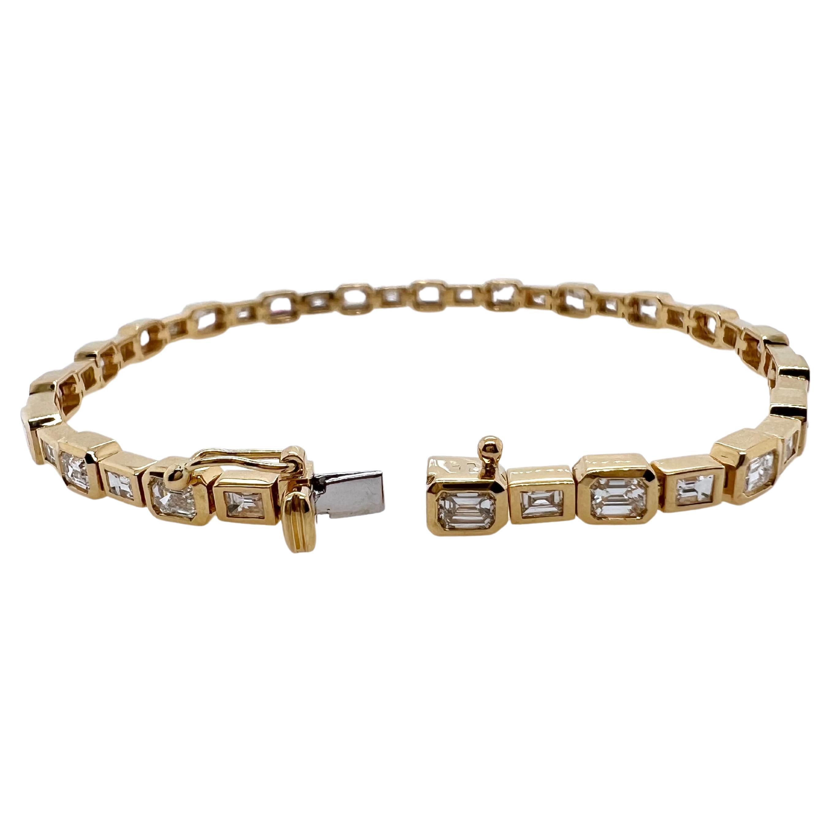 This stunning diamond tennis bracelet is comprised of emerald cut diamonds and baguette diamonds that are
bezel set in an alternating pattern.  The variation in sizes gives the bracelet a unique, contemporary look.  It can be
worn daily and will be