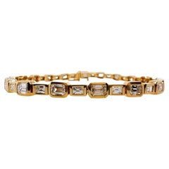 Bracciale Tennis in oro giallo 18k con diamanti taglio smeraldo e baguette