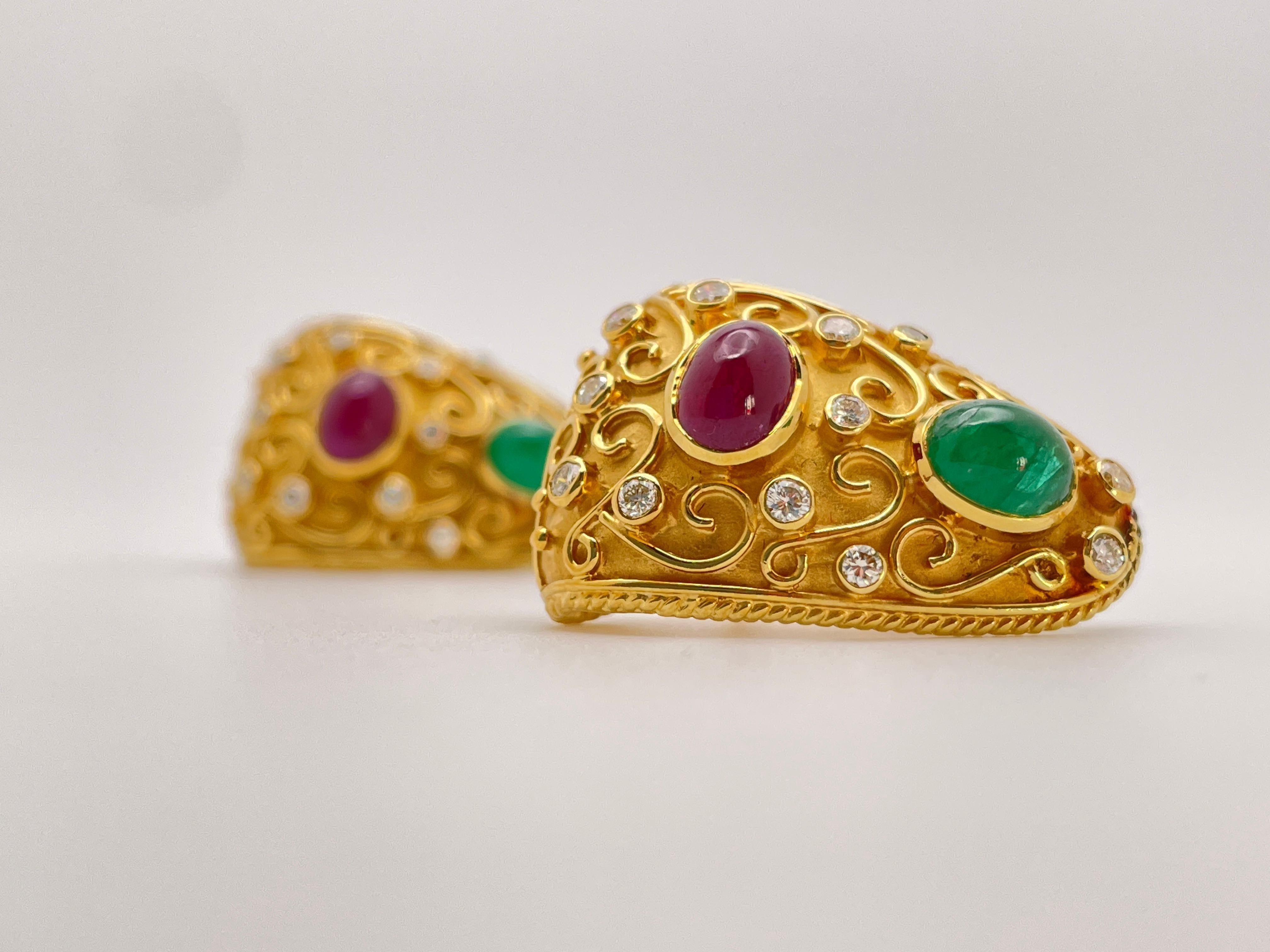 This original pair of 18K yellow gold Byzantine style earrings features an intricate design, set with a beautiful combination of diamonds, emeralds, and rubies.

Set with 24 round brilliant cut diamonds totaling approximately 1.50 carats.