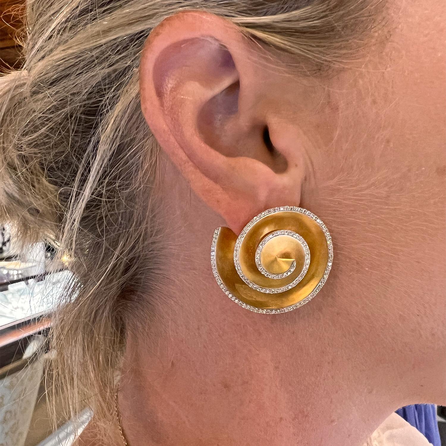 Fibonacci spiral design earrings in 18k yellow gold, the edges adorned by round brilliant-cut diamonds.  Posts with friction backs for pierced ears. 1.25