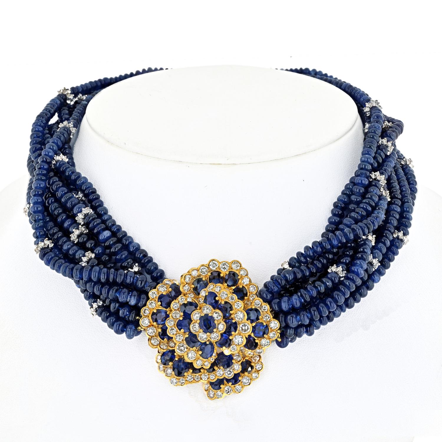 Dive into the lavish allure of this Sapphire Beads 18K Yellow Gold Diamond Flower Multi-Strand Necklace—a testament to opulence and craftsmanship. Comprising nine graduated strands of genuine blue sapphire beads, this estate necklace is a statement