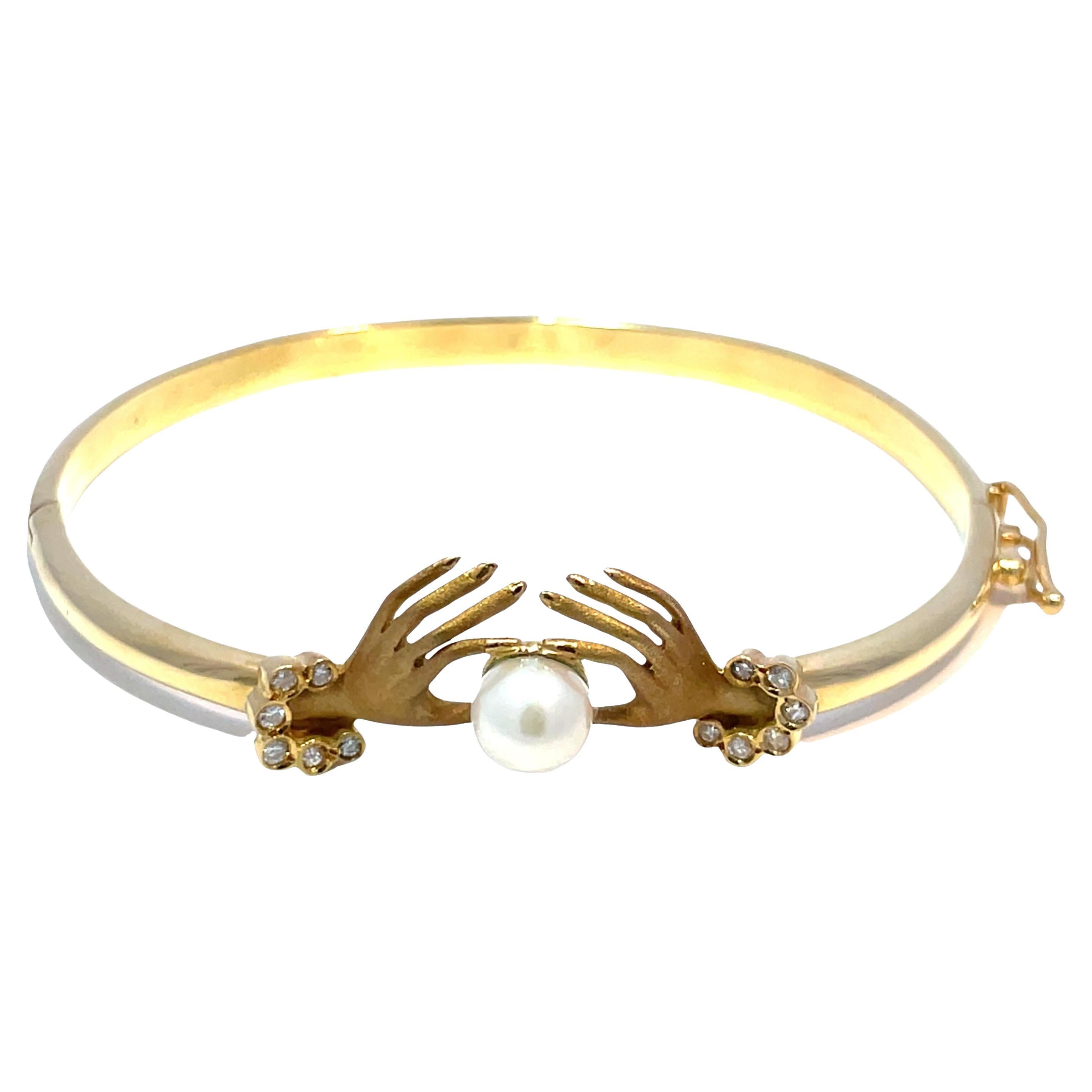 18k Yellow Gold Diamond Hand Holding Pearl Bangle Bracelet For Sale