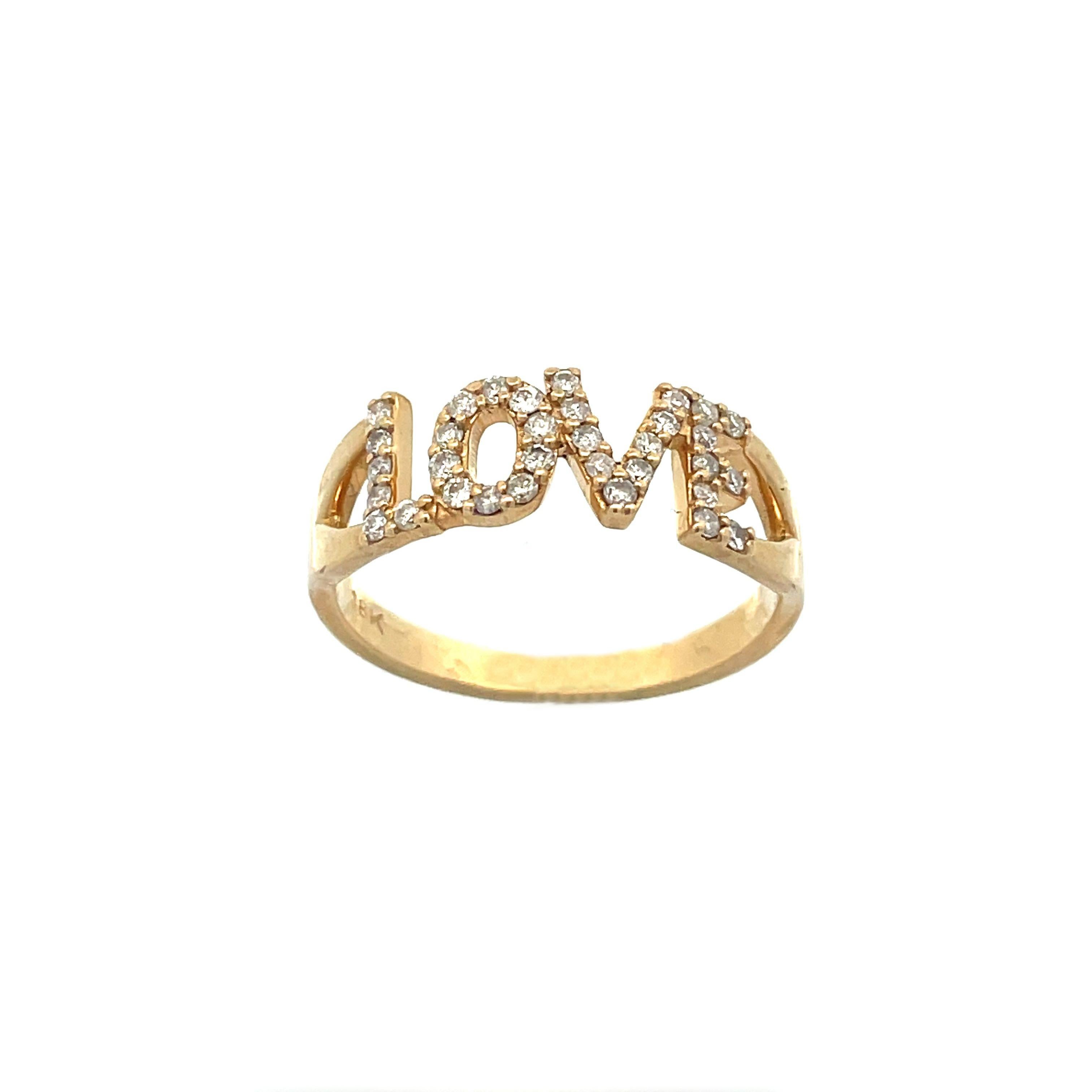 This is a beautiful Contemporary ring crafted in 18K yellow gold that showcases a sparkling collection of diamonds that spell 