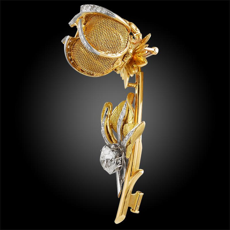 A quintessentially elegant suite from the 196os, comprising an 18k yellow gold mesh and diamond flower brooch with matching ear clips. Each piece features brilliant cut diamond accents and mesh petals that open and close, which can be worn to your