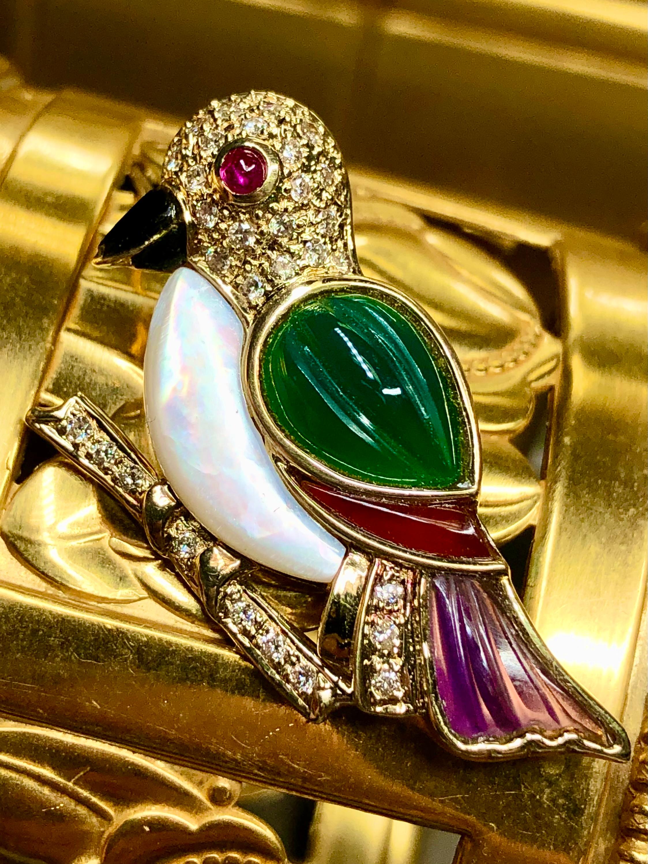A lovely little brooch that can also be worn as a pendant. It is done in 18K yellow and set with .43ctw in H-I color Vs2-Si1 clarity round diamonds and inlaid with mother or pearl, green chalcedony, amethyst, onyx, agate and a ruby for the