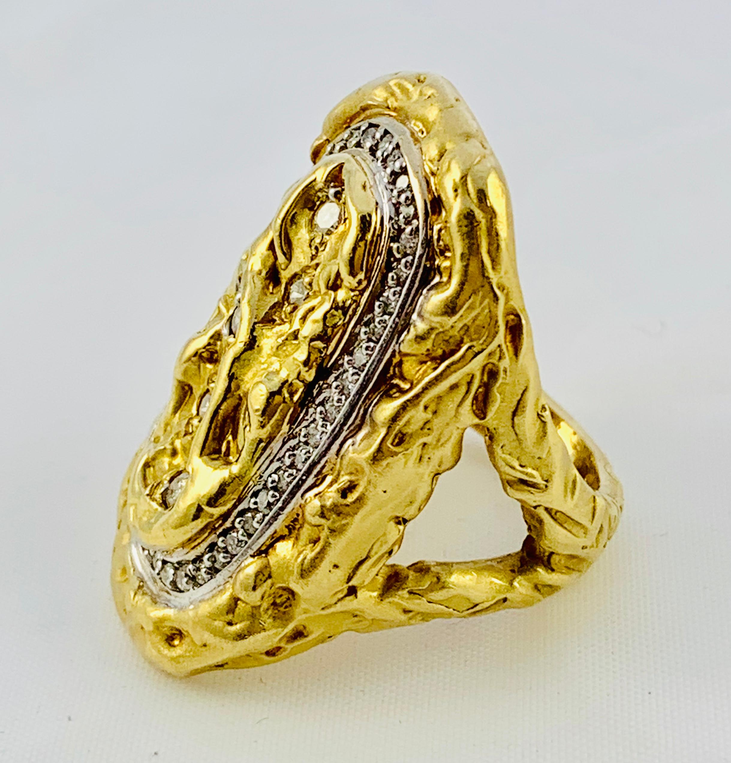 Absolutely Gorgeous Saddle Ring! Made in beautifully Carved 18K yellow Gold and features an oval rim of diamonds that frame in 5 larger round diamonds in the center. The size of the ring is 6.25, it weighs 18.8 grams. The dome measures 1.25 inches
