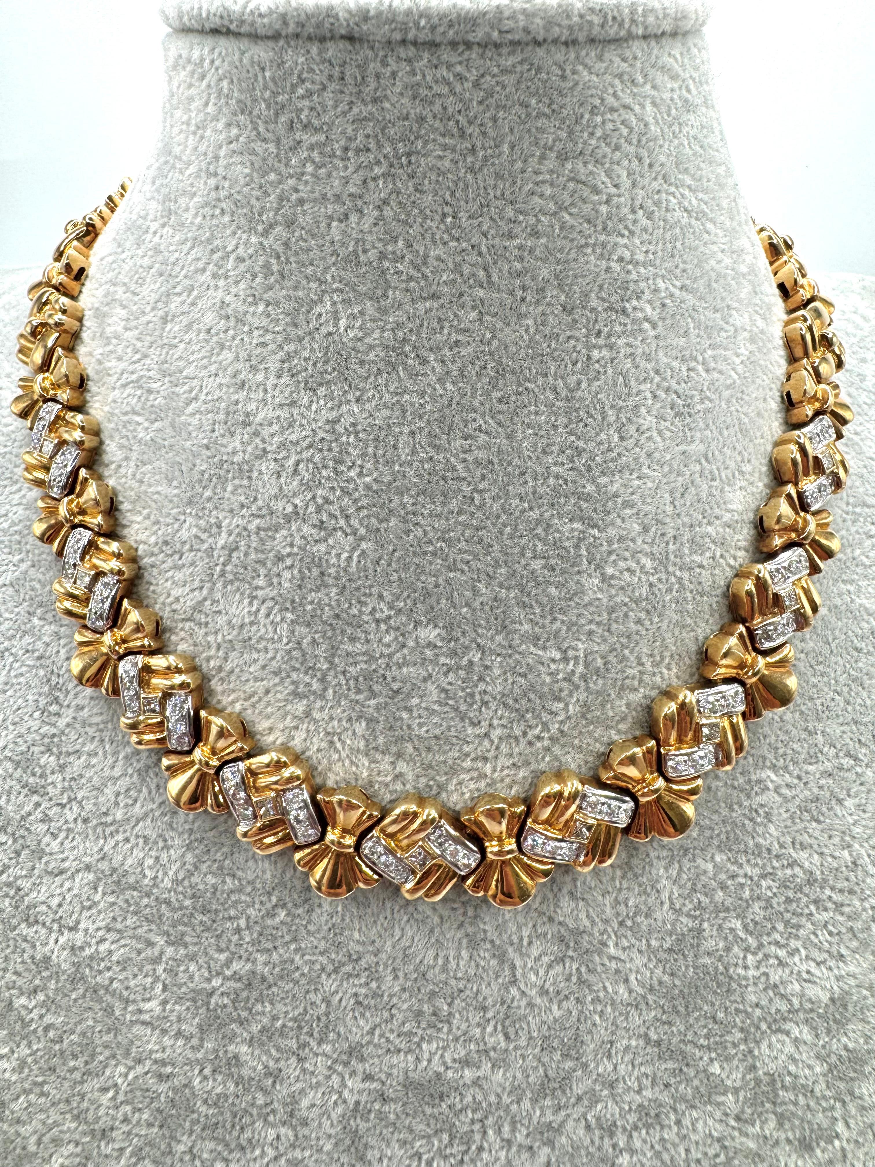 Crafted in rich 18K yellow gold by Elan USA, this vintage choker necklace from the 1980s features a bold, sculptural design with repeating bow or ribbon-style links. Each gold segment is accented by chevron-shaped rows of brilliant-cut diamonds,