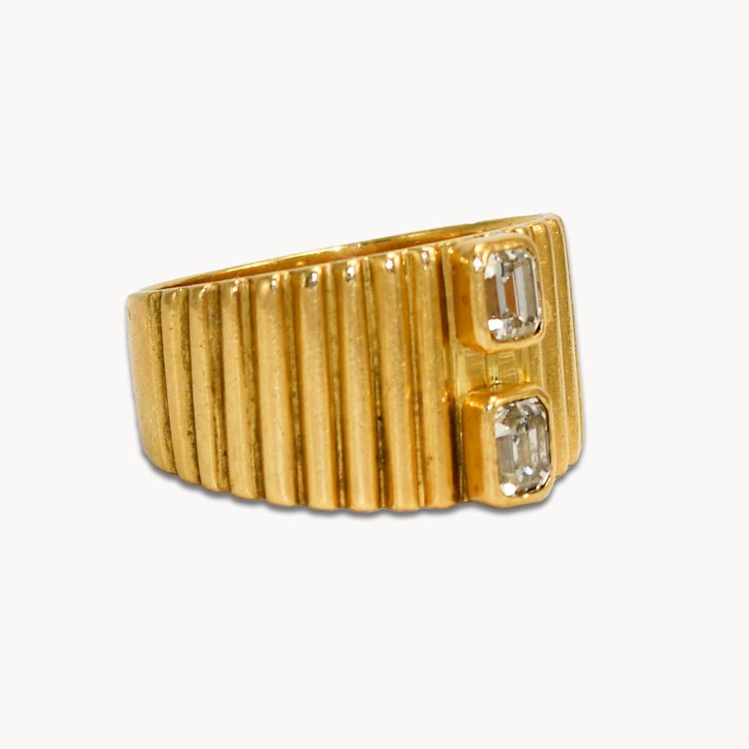 18k Yellow Gold Diamond Ring.
Set with two 0.15ct Emerald Cut Diamonds. Both are bezel set, L-M Color, and VS Clarity.
Tests 18k, weighs 7.4 grams.
Size 7 3/4.