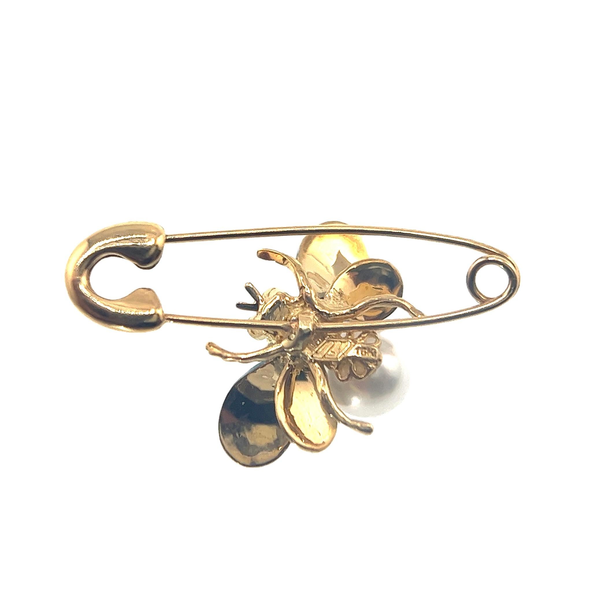 18K Yellow Gold Diamond & Sapphire Bee Paper Clip Brooch Pin 

1 Pink Sapphire - 0.20 CT
1 Pearl -7mm
2 Diamonds - 0.014 CT'
18K Gold - 4.25 GM

The exquisite 18K Yellow Gold Diamond Bee Paper Clip Brooch Pin, a stunning piece that elegantly