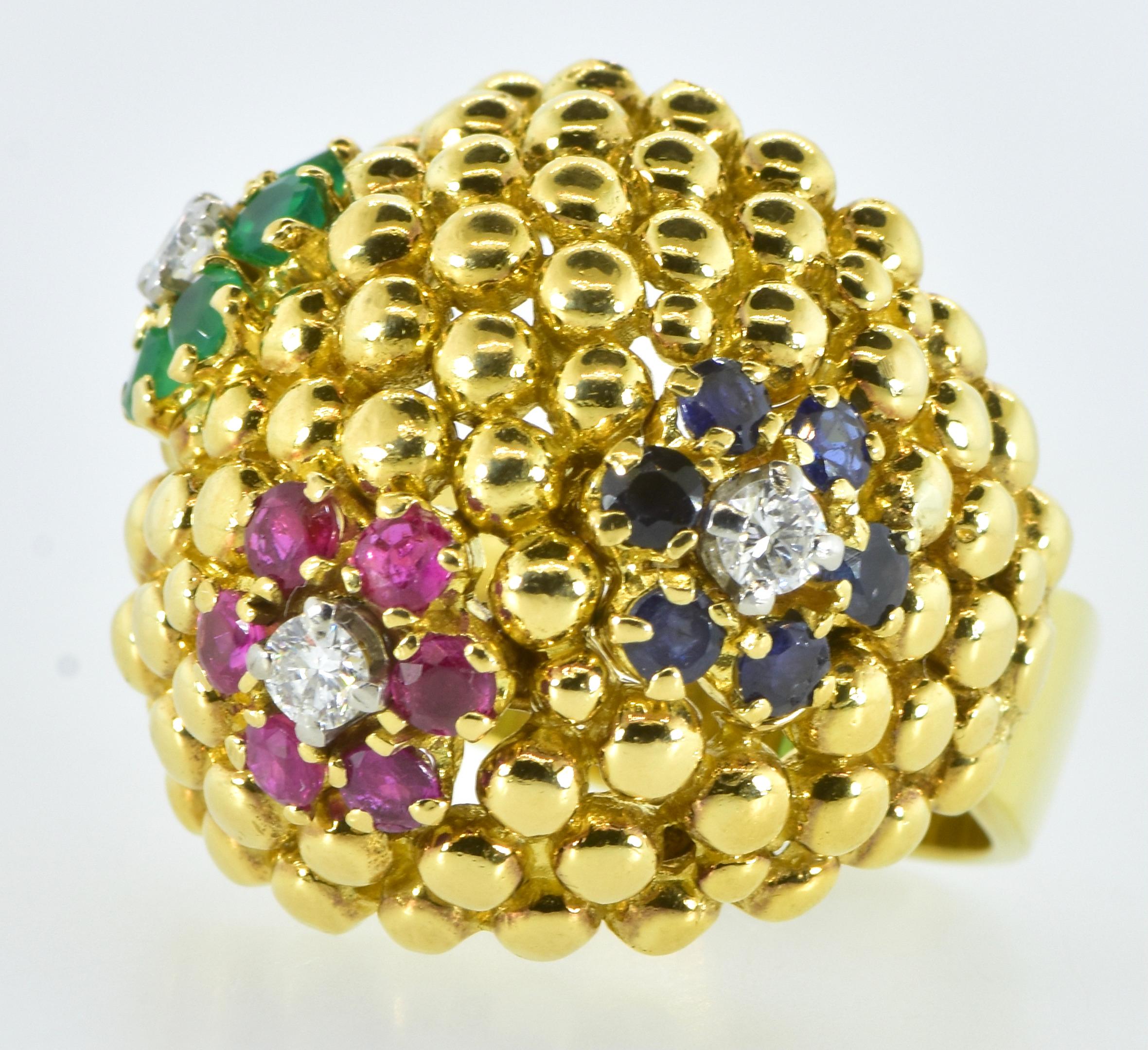 18K yellow gold, fine diamond, sapphire, ruby and emerald ring made in the early 1960's. This heavy and substantial ring in 18K, and marked on the interior of the shank weighs 20.7 grams.  The gold bead work is done well and shows off the flower