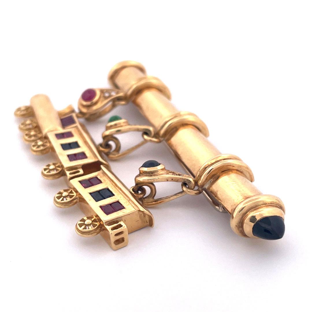 Embark on a whimsical journey with our exquisite 18K yellow gold train brooch. This captivating piece showcases a delightful train design, featuring a 3 cart train set with gemstones and decorated with diamonds. Weighting 31.8 gram this brooch is a