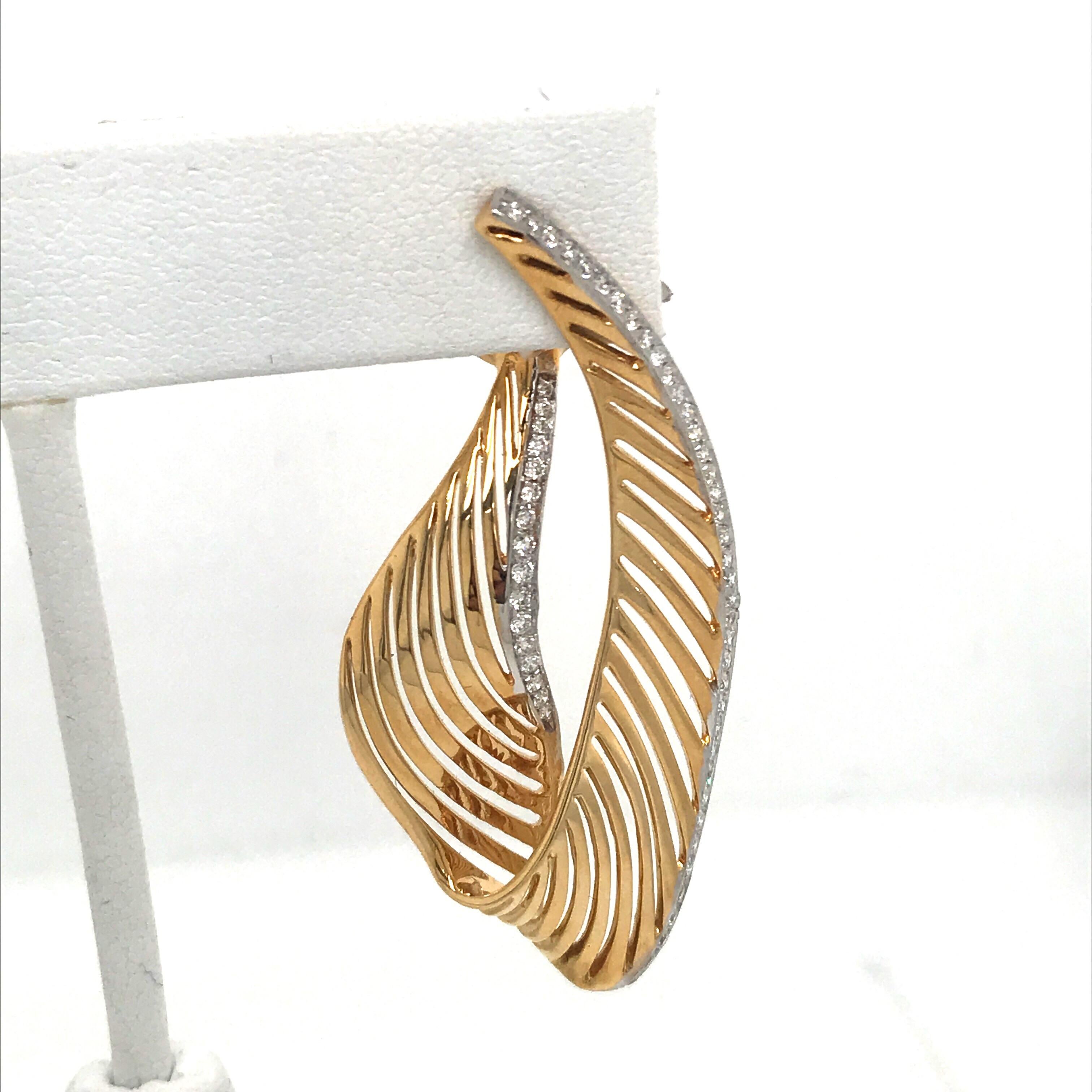18K Yellow gold swirl drop earrings featuring 112 round brilliants weighing 1.03 carats. 
Color H
Clarity SI