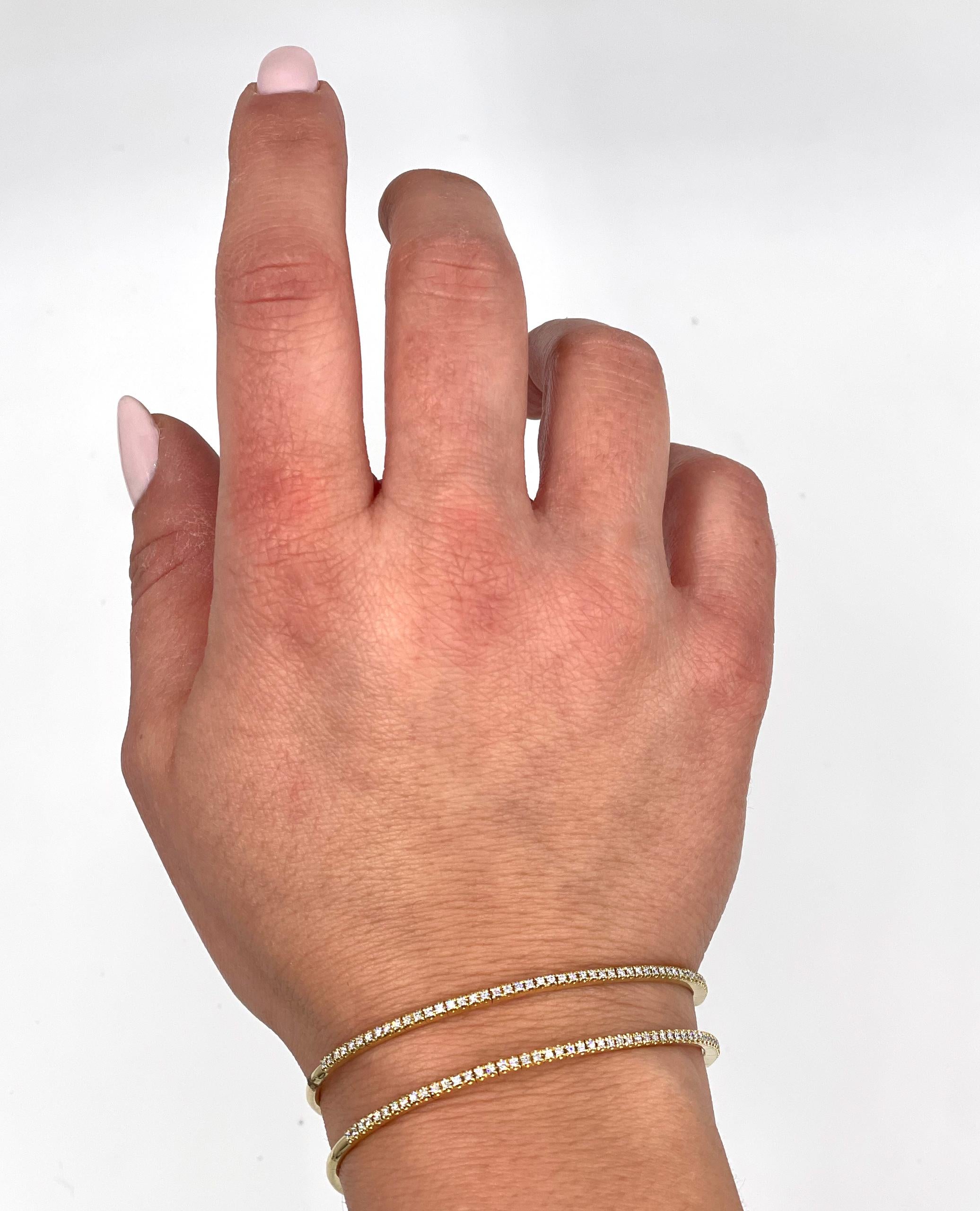 18K yellow gold semi flexible wrap bangle bracelet with round brilliant-cut diamonds weighing 0.80 carats total: F/G Color, VS2/SI1 Clarity.