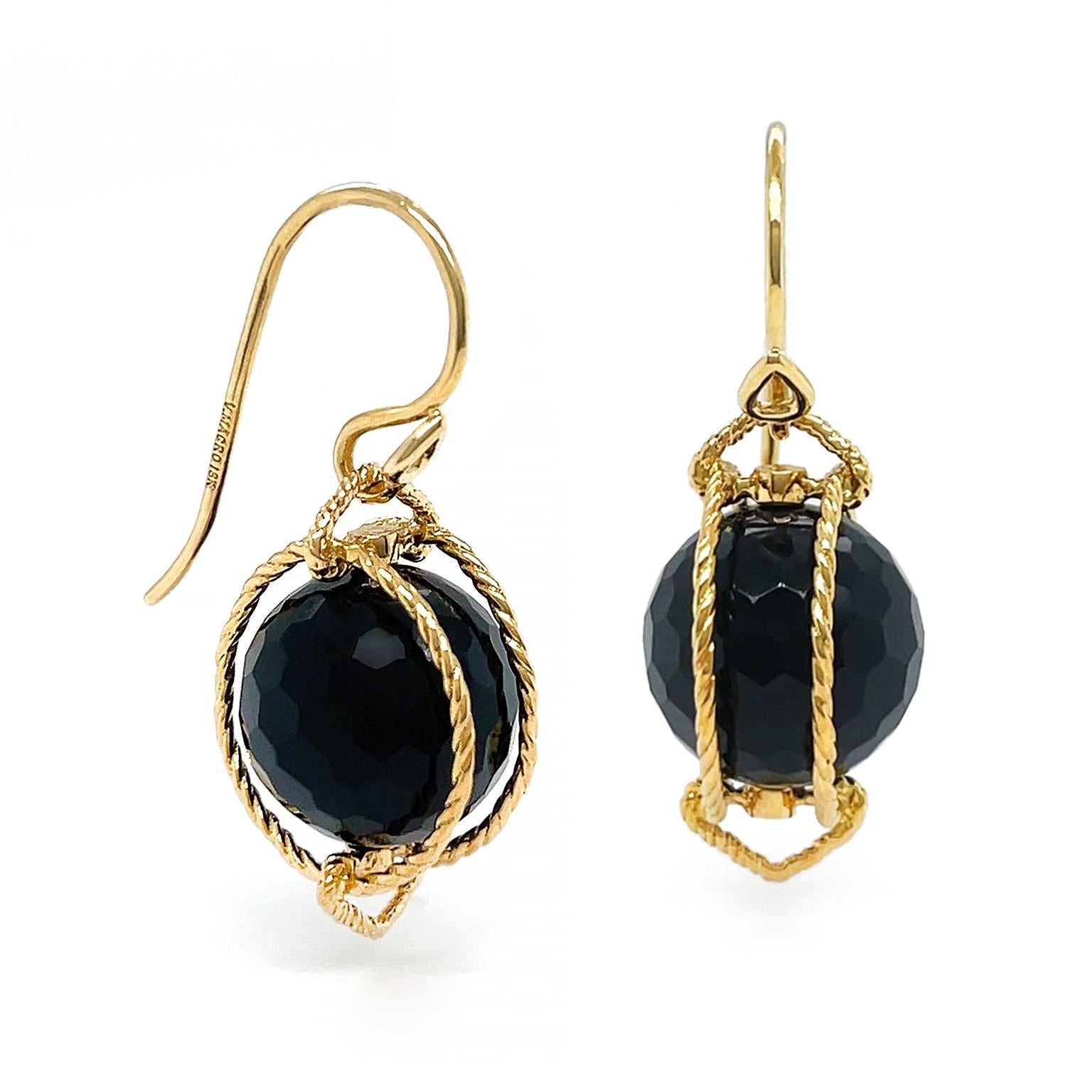 Black onyx and gold are beaming pairs for these earrings. Descending from French hooks, 18k yellow gold textured to resemble rope, creates openwork triangular shapes above and below the gem. In between vertical ropes secure a facetted orb of black