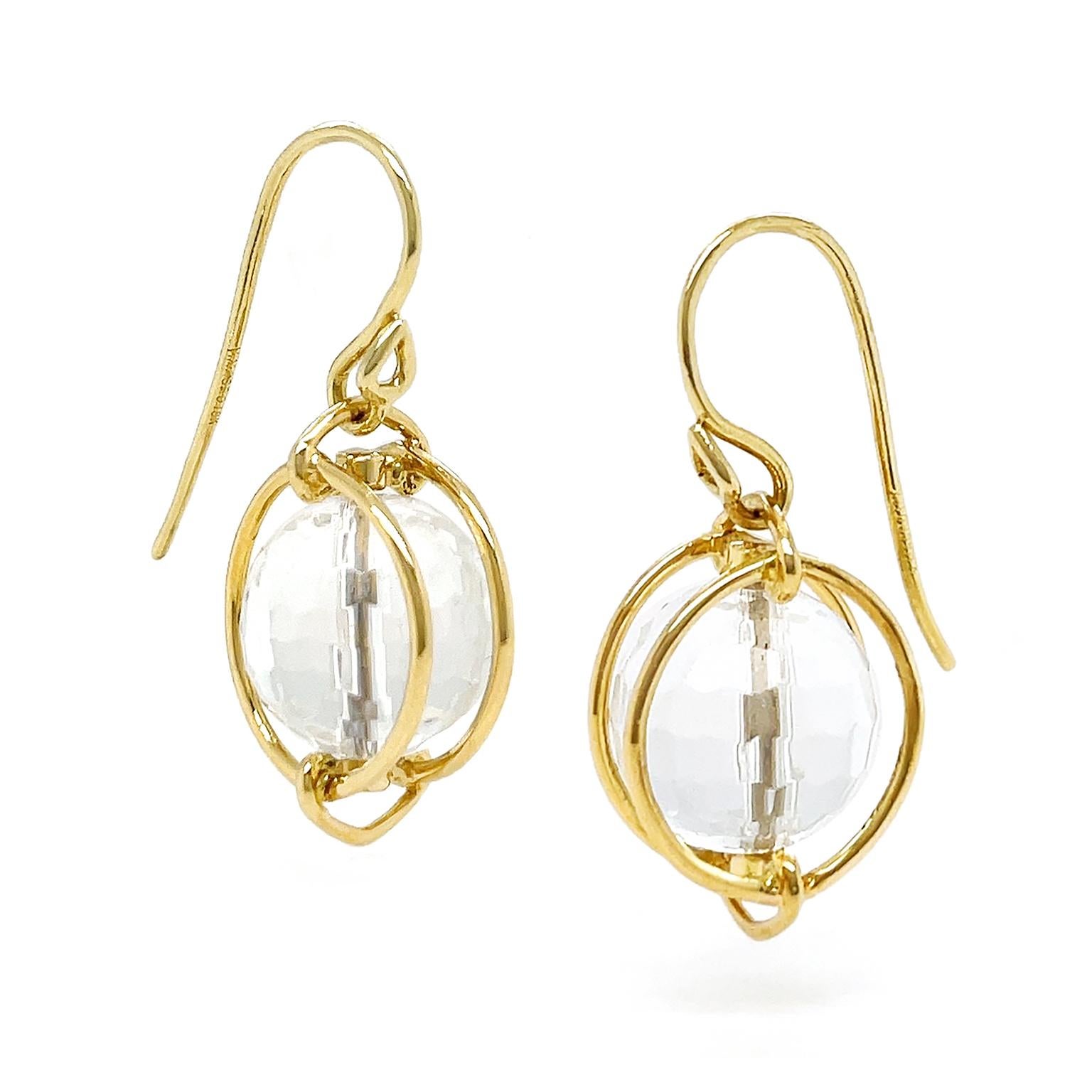 A lustrous crystal is paired with the radiance of 18k yellow gold for these drop earrings. A globe of crystal is double-faceted to play off the light. The gold wire within the crystal holds it in place, while a pair of gold hoops secured to a