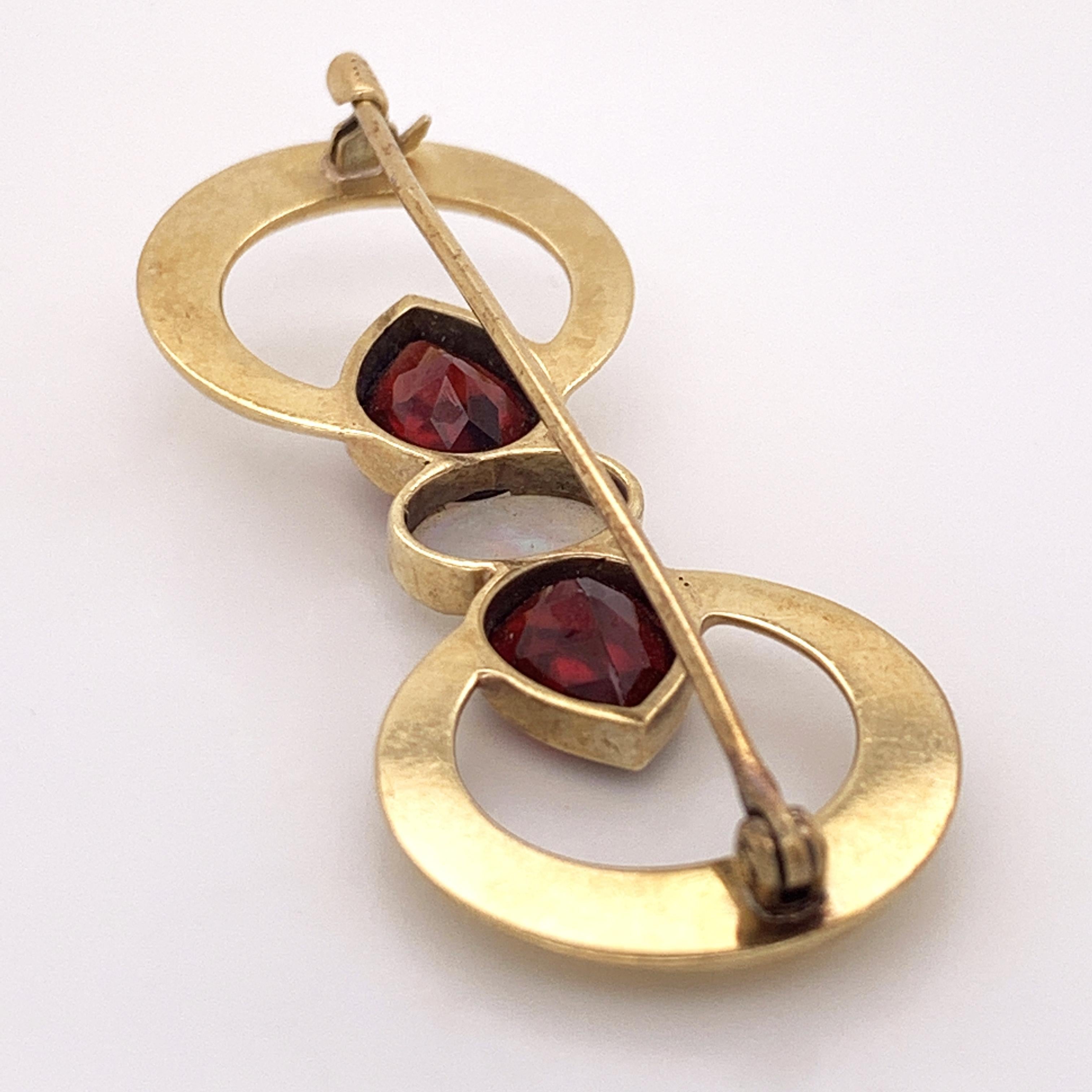 Oval Cut 18 Karat Yellow Gold Double Ring Brooch with Opal and Garnet Stones