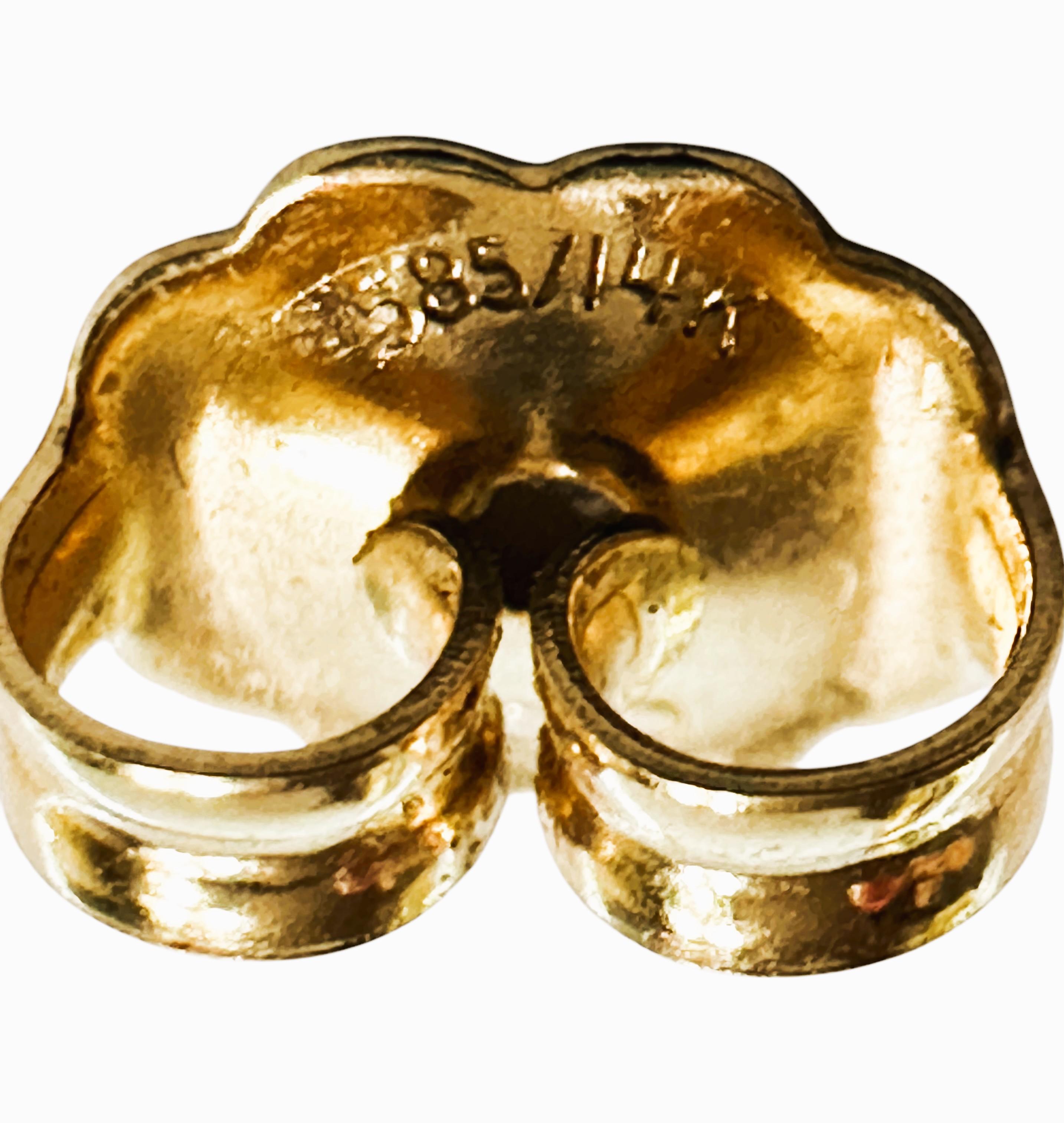 These earrings are just beautiful!  They are 18k yellow gold and one ring is high polish and the other ring is textured.  They are not stamped but test as 18K.  See Photo.  The earrings are 20 mm long and 17.5 mm wide.  They are pre-owned but in