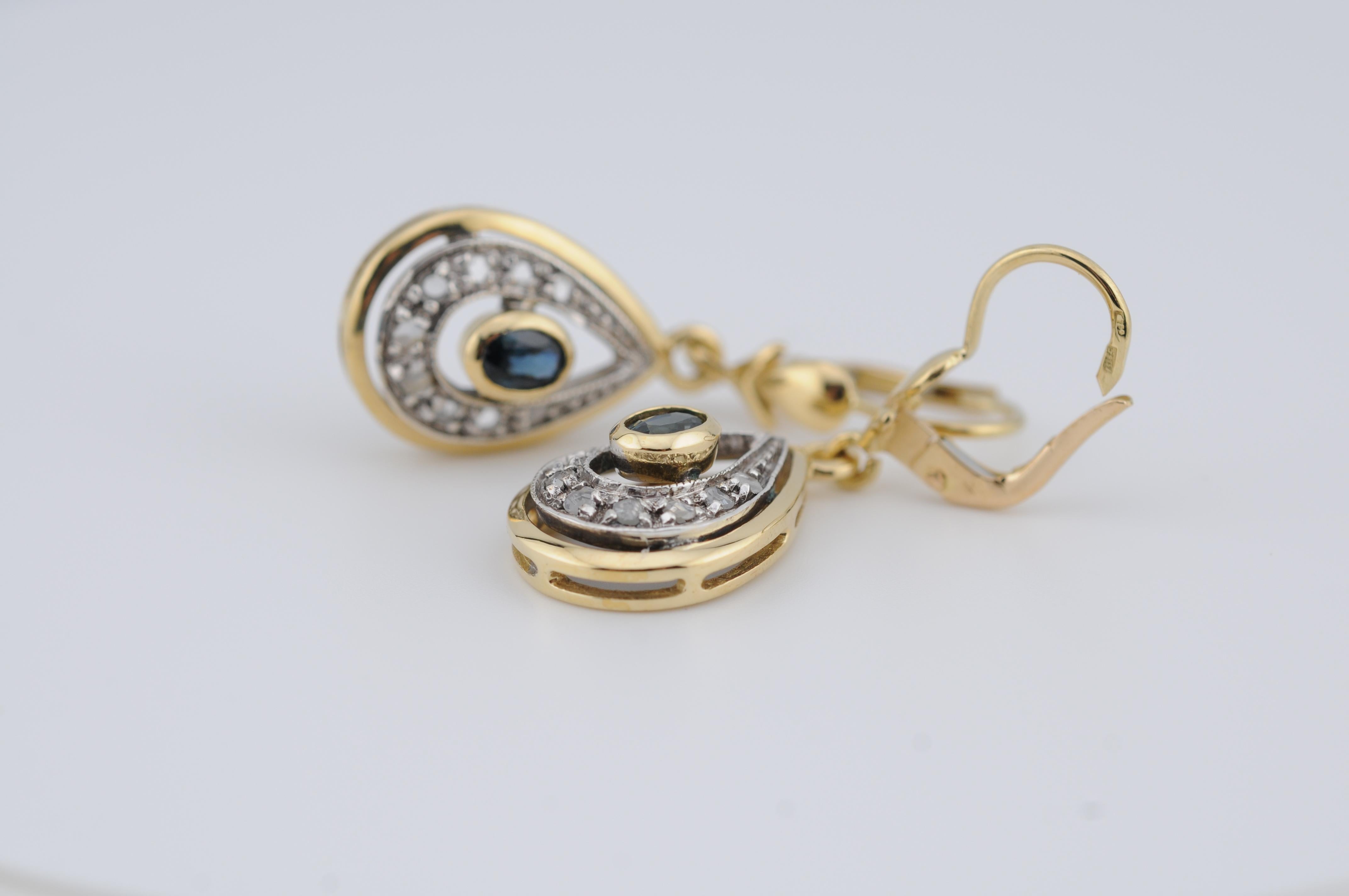 18k Yellow Gold Drop Earrings with Rose-Cut Diamonds and Blue Sapphires

Stones: Blue Sapphires, ~0.50 ct total
Diamonds: Rose Cut
Elegant 18k yellow gold drop earrings, featuring shimmering rose-cut diamonds paired with vibrant blue sapphires for a