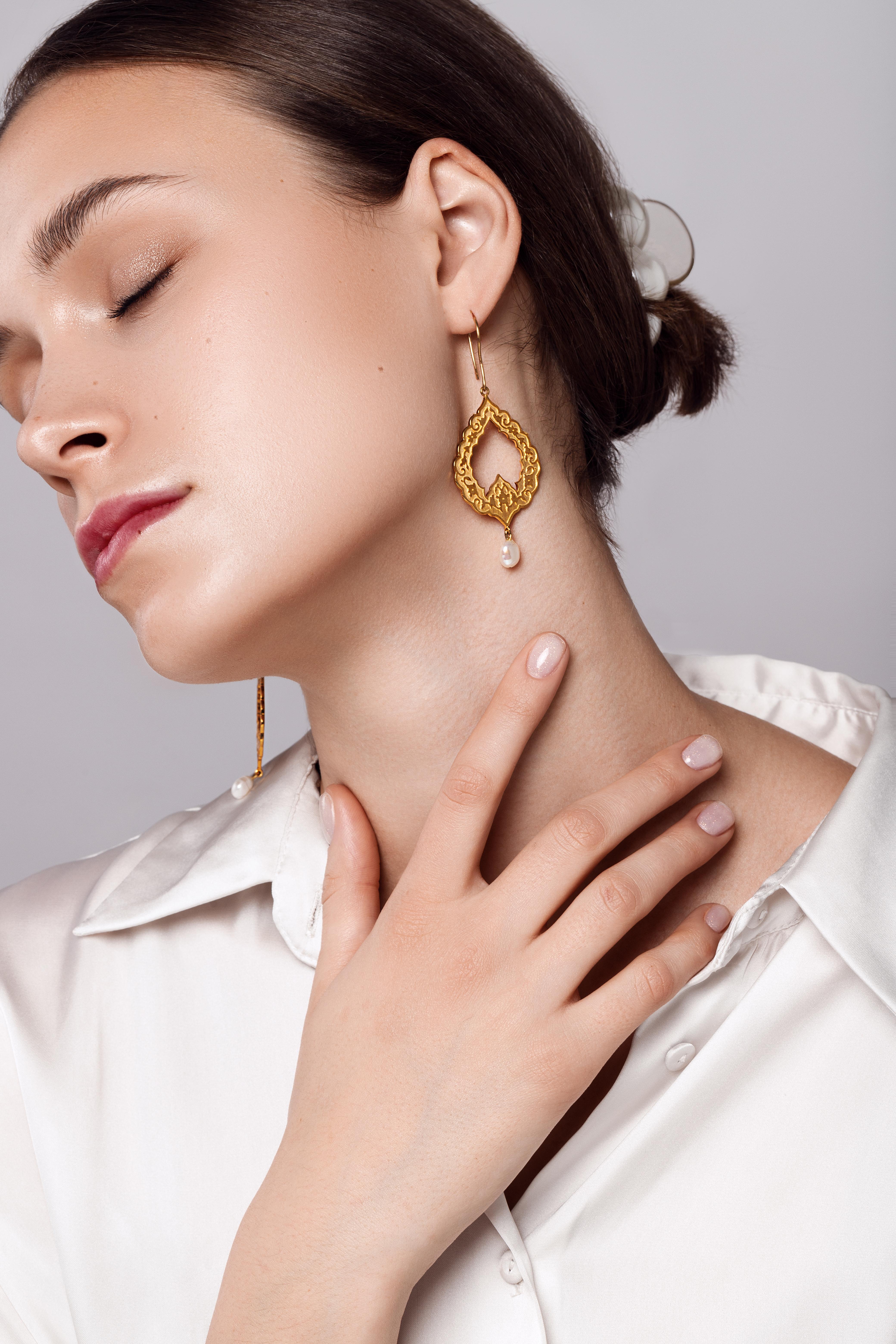 Eslimi earring hand crafted by extremely skilled hands in 18K yellow gold & natural baroque pearl and was inspired by arabesque and Middle eastern art & architecture. This timeless and gorgeous earring has delicate pattern on both sides and is