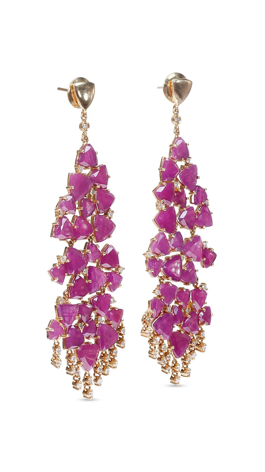 A luxurious earrings with 50 dazzling 33.80 carat natural rubies and 53 elegant 0.47 carat round brilliant side diamonds which add more to its elegance. The jewelry is made of 18K yellow gold with a high-quality polish. It comes with an AIG