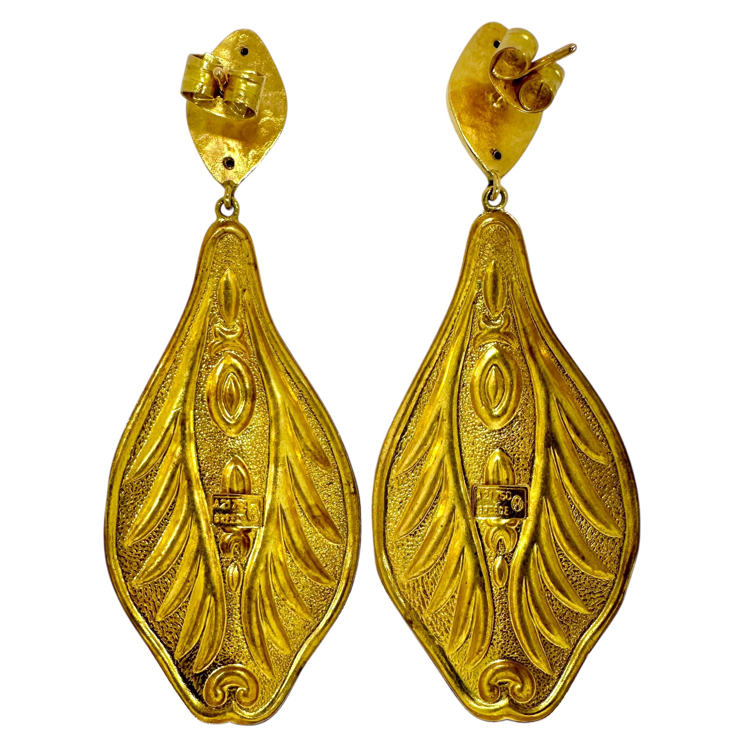 This feminine pair of vintage Lalaounis 18K yellow gold dangle earrings are quite long at 2 3/4 inches. They are gracefully curved creating a subtle bombe appearance. All raised surfaces are high polish finish set against a background of satin