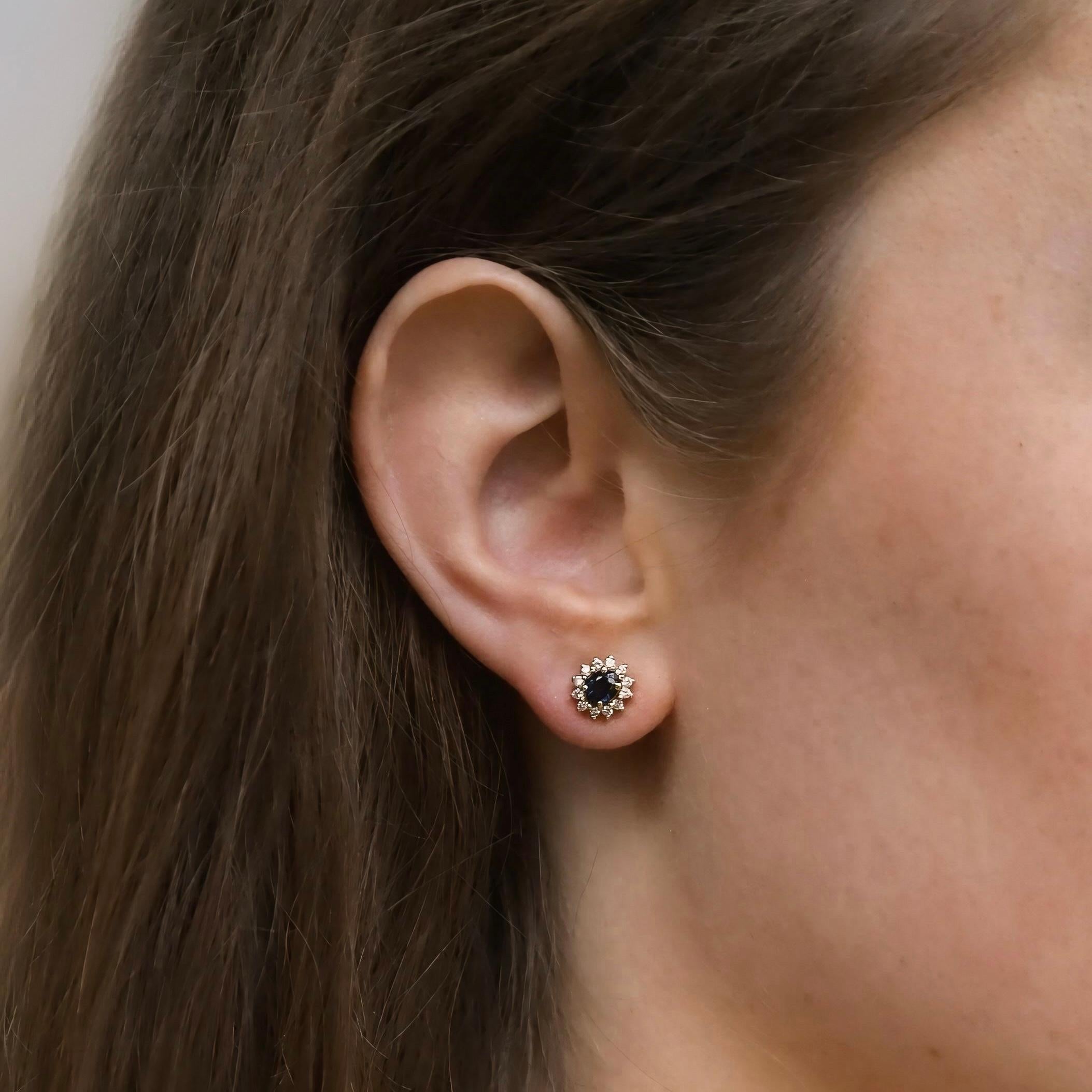 Oval Cut 18k yellow gold earrings with 12 brilliant cut diamonds and oval blue sapphire For Sale