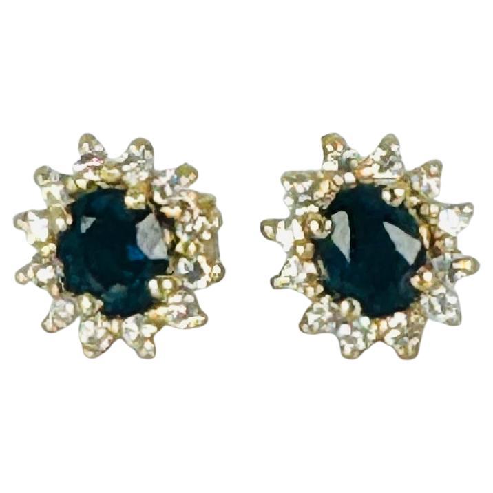 18k yellow gold earrings with 12 brilliant cut diamonds and oval blue sapphire