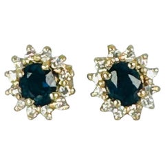 18k yellow gold earrings with 12 brilliant cut diamonds and oval blue sapphire
