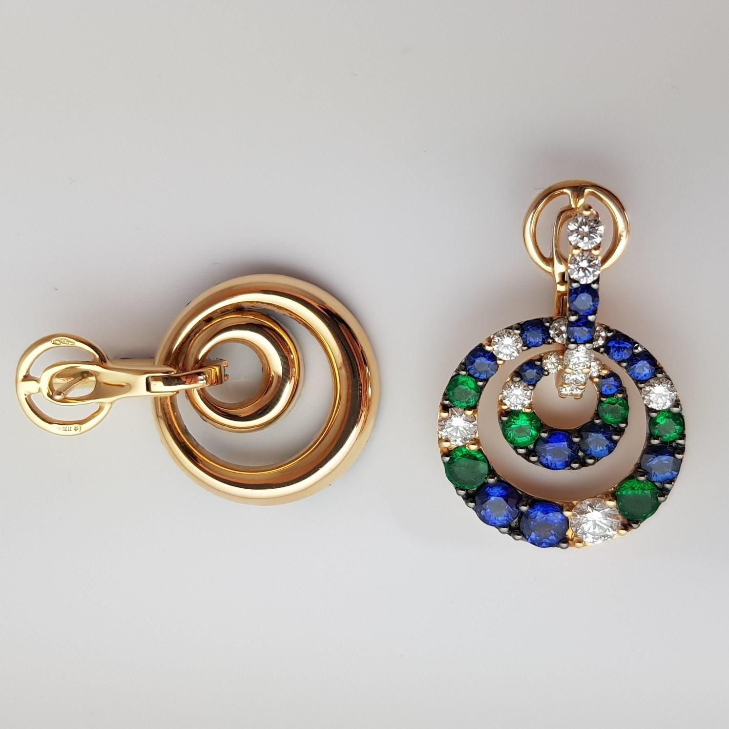 Double circle earrings set in 18K Yellow Gold embellished with 1.78 carats of Diamonds, 1.55 carats of Emeralds and 3.33 carats Blue Sapphires