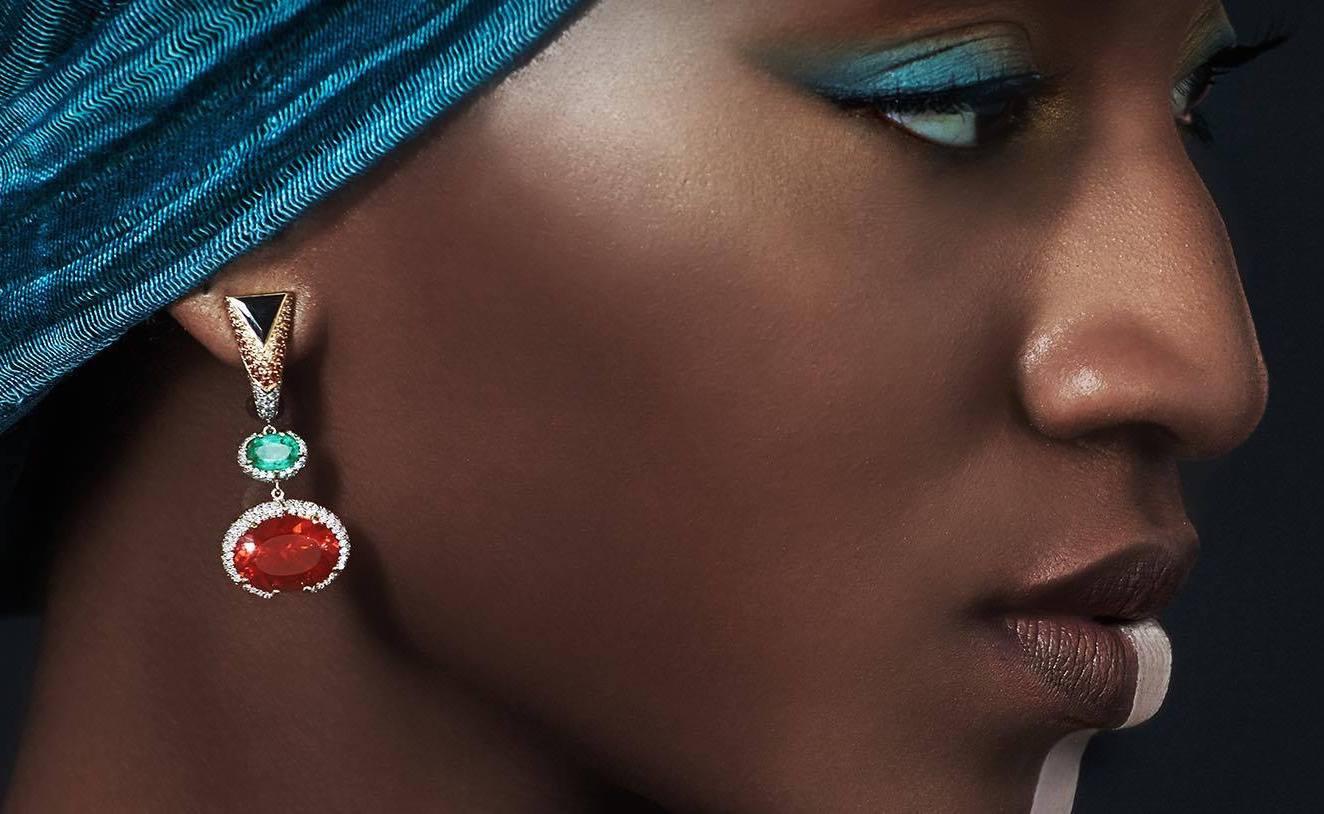 Africa collection by VOTIVE.

Emanating celestial allure, the Olapa earrings draw inspiration from the Maasai moon Goddess. Crafted from 18k yellow gold, they showcase the fiery splendor of Mexican Fire Opals, reminiscent of Olapa's passionate
