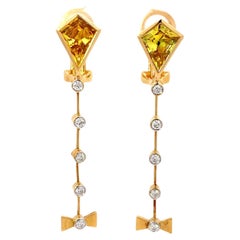 Orecchini in oro giallo 18K con diamante bianco e zaffiro giallo