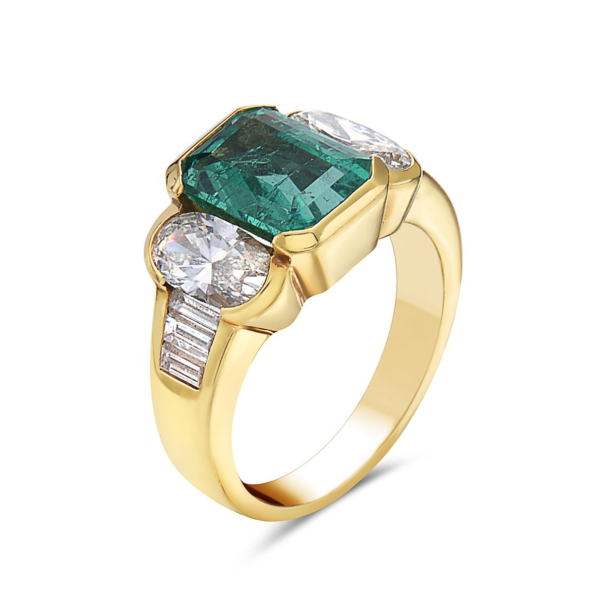 This cocktail ring features a 3.70 carat Emerald flanked by two long oval diamonds and six baguettes weighing 2.50 carats set in 18K yellow gold. Size 6 1/4.

Resizeable upon request.

Viewings available in our NYC showroom by appointment.